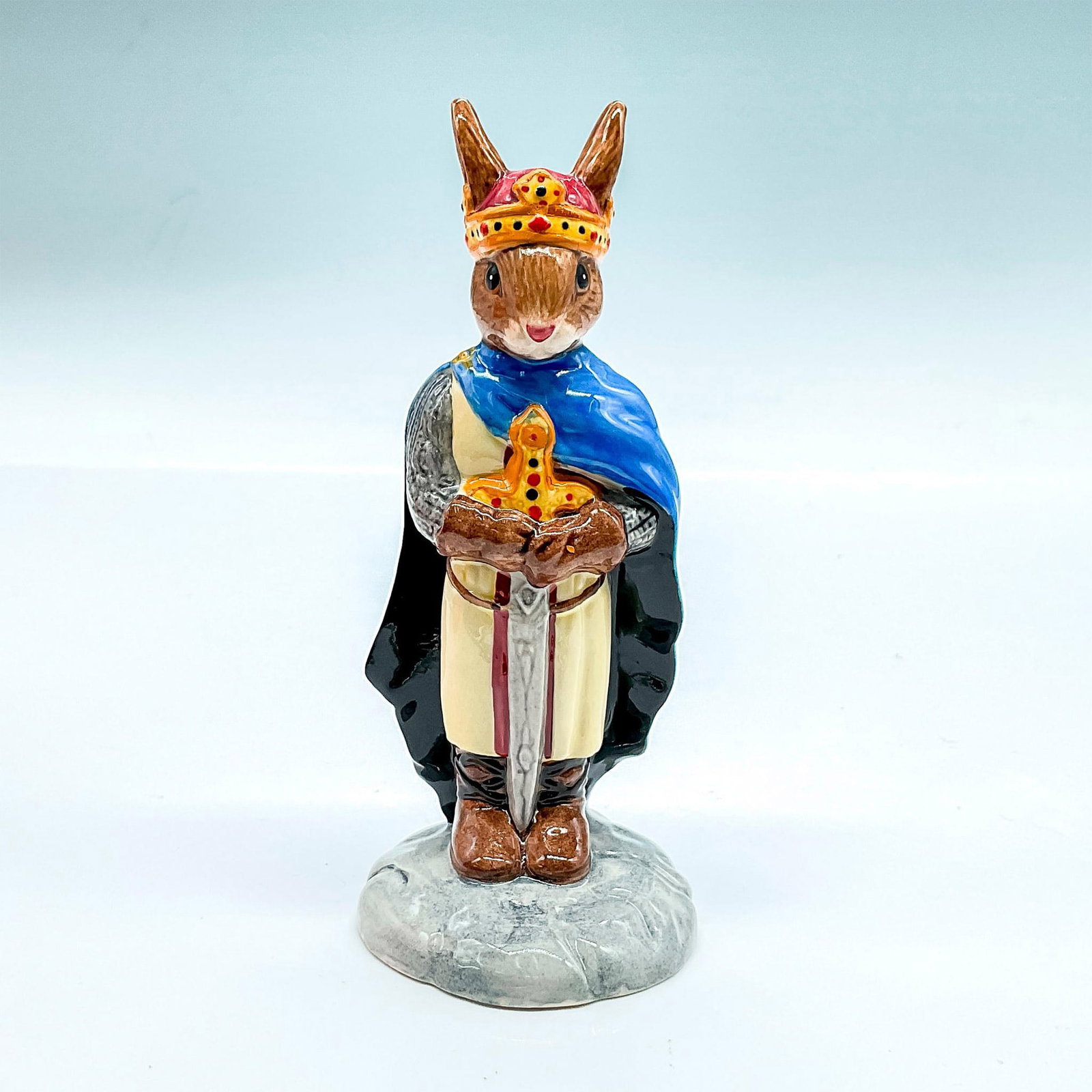 Royal Doulton Bunnykins Figurine, King Arthur DB304: Box included. Box measures approximately 2.5"L x 3.5"W x 5.75"H. Artist: C. Dadd Issued: 2004 Dimensions: 4.75"H Manufacturer: Royal Doulton Country of Origin: England
