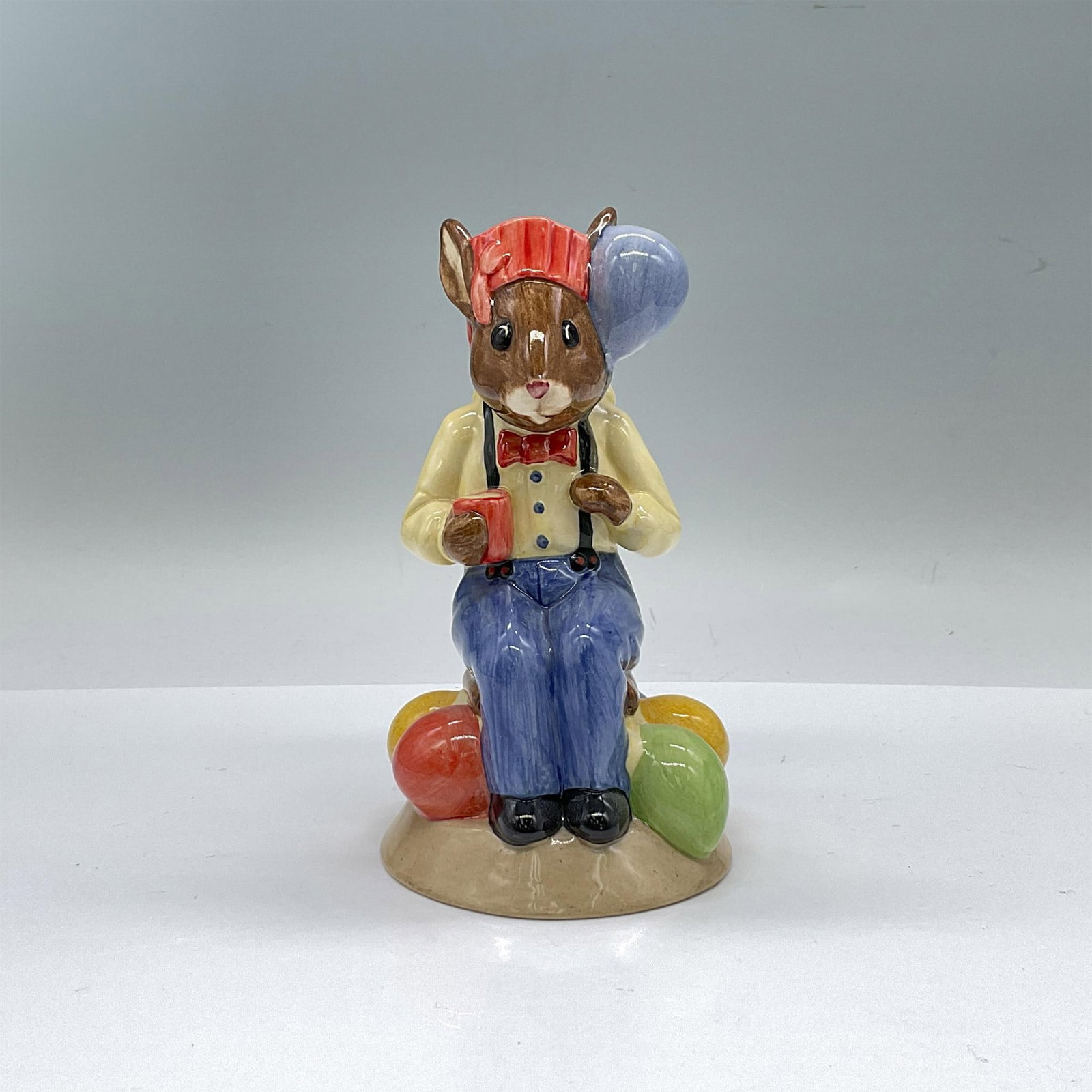 Royal Doulton Bunnykins Toby Jug, Party Time D7160: Limited edition, glossy porcelain, bunny is modeled in blue pants, yellow shirt and red hat and colorful balloons. Second in the Series of Bunnykins Toby Jugs Classic. Royal Doulton Bunnykins backstam