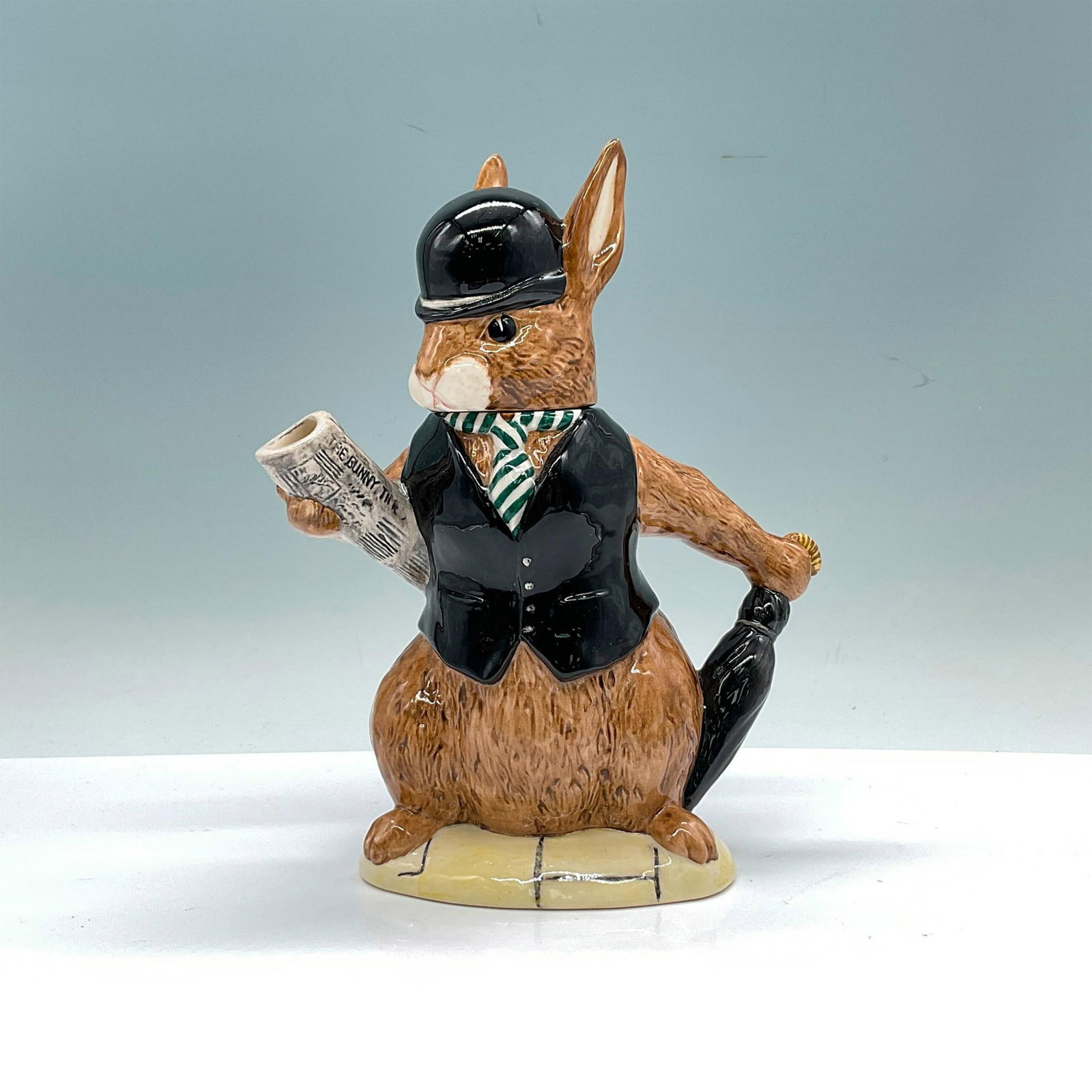Royal Doulton Bunnykins Lidded Teapot London City Gent D6966: Special edition of 2000 porcelain sophisticated bunny with removable lid headpiece modelled in a black vest and bowler hat holding a newspaper under one arm and an umbrella in the other. Royal Doulton