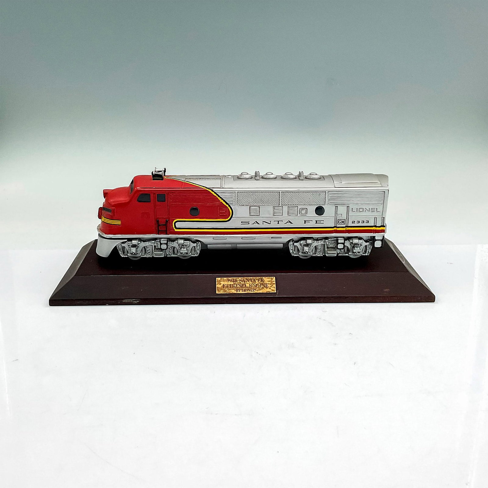 Lionel 1948 Santa Fe F3 Diesel Engine, Avon 1992: Avon collectible replica of the original locomotive, 8.75"L x 1.75"W x 2.5"H. Includes wood base, 11"L x 4.25"W x 1"H. Manufacturer: Lionel Country of Origin: United States