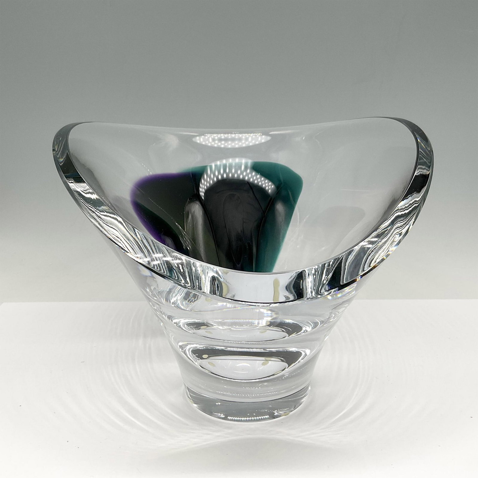 Goran Warff for Kosta Boda Crystal Bowl, Aria: Beautiful sleek contemporary slanted bowl with blended green and purple glass. Signed by Artist. Kosta Boda etched mark. Artist: Goran Warff Issued: 21st century Dimensions: 8"L x 11"W x 6.5"H Manufac