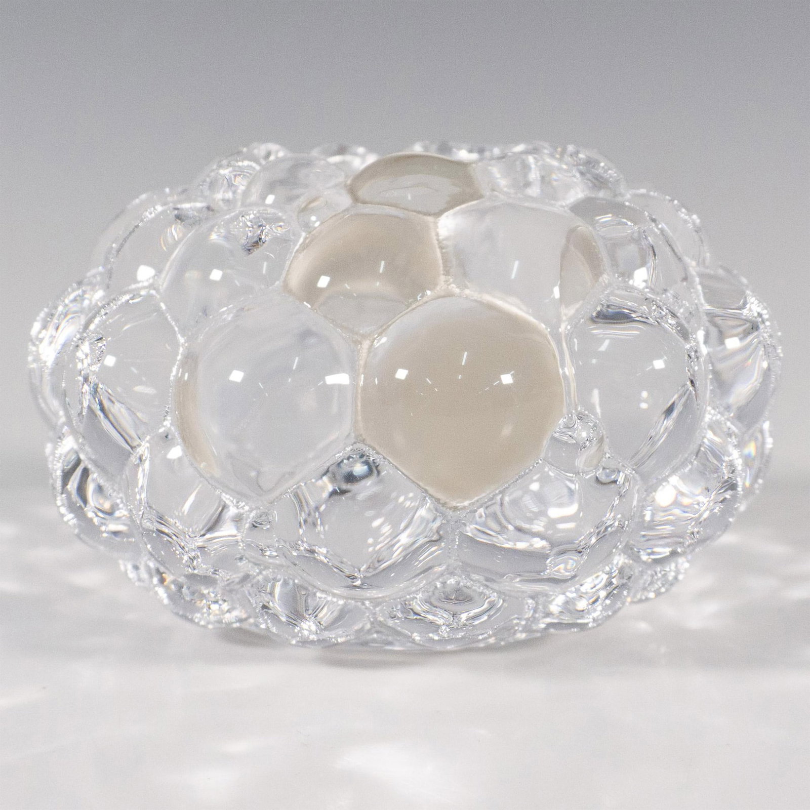 Orrefors by Anne Nilsson Crystal Candle Holder, Raspberry: A clear votive candle holder in a round cluster form. Orrefors marked. This item has its original box: 4.5"L x 4.5"W x 3"H. Artist: Anne Nilsson Issued: Late 20th to 21st century Dimensions: 4.25"W x