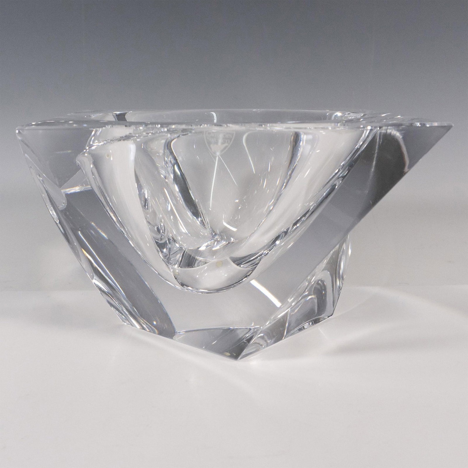 Orrefors by Jan Johansson Crystal Bowl, Tornado: A clear, smooth, square-formed bowl with a twist. Orrefors stickered and etched markings. Artist: Jan Johansson Issued: c. 2003-2016 Dimensions: 7"L x 7"W x 4.5"H Manufacturer: Orrefors Country of Or