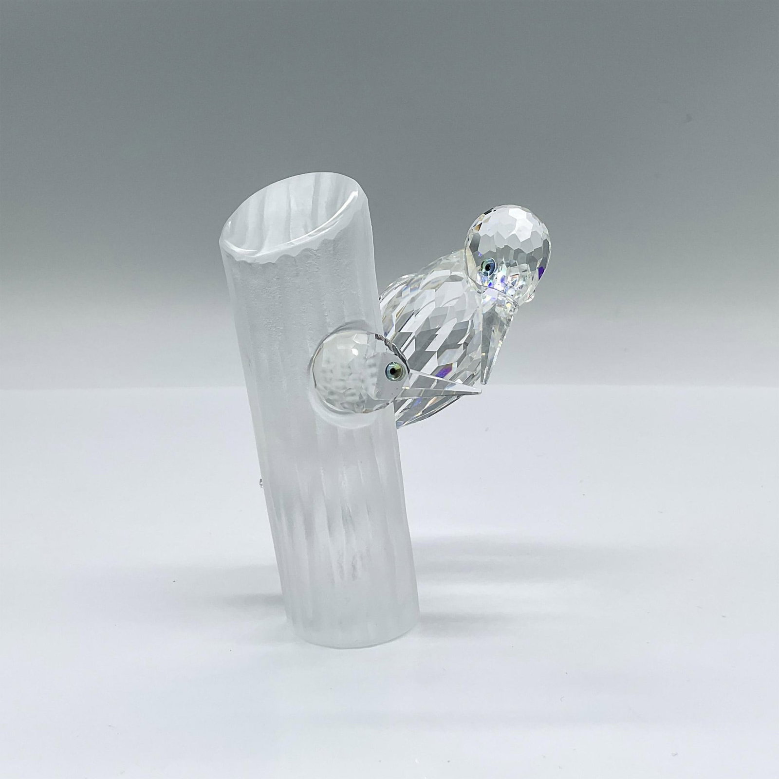Swarovski Crystal Society Figurine, Woodpeckers - Sharing: Part of the Caring and Sharing trilogy, and the second annual edition made for SCS members. Features a parent woodpecker and a baby in a clear facetted body with long clear beaks and colored eyes. Eac