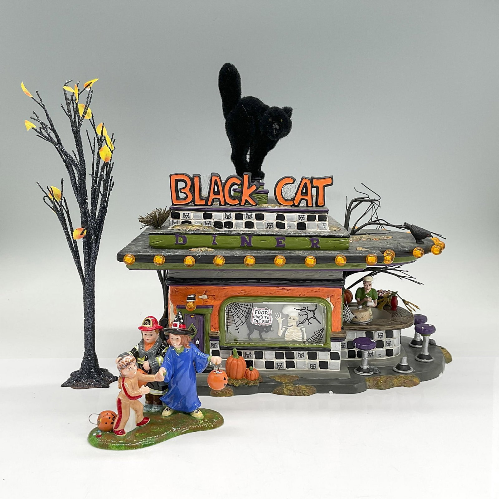 Department 56 Halloween Village Display, Black Cat Diner: Detailed resin display building as a spooky Halloween themed diner. Black fuzzy cat on top is removeable. Includes original box; 14"L x 8"W x 13.75"H. Dimensions: 10.5"L x 7.5"W x 10.5"H Manufacturer: