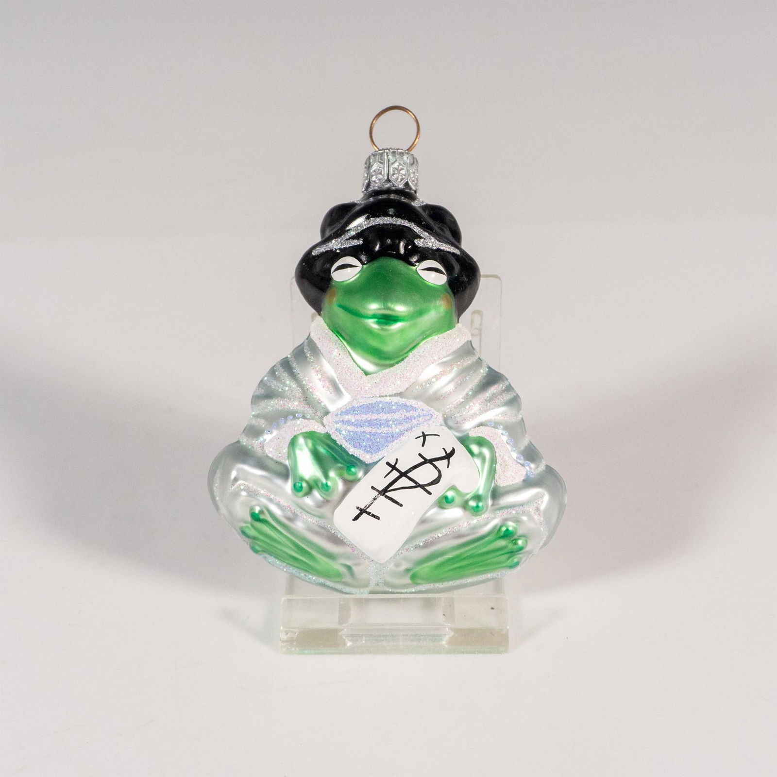 Patricia Breen Christmas Ornament, Geisha Frog: Hand-painted glass ornament influenced by the book Memoirs of a Geisha and fashioned after traditional Japanese prints for styles of hair and clothing. Issued: 2000 Dimensions: 2.75"L x 1.75"W x 3"H M