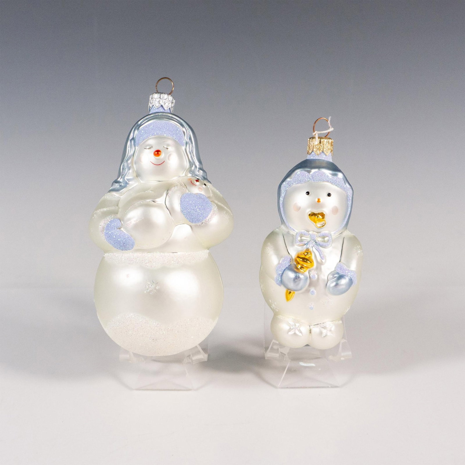 2pc Patricia Breen Ornaments, Snow Baby and Snow Mary: This pair of handcrafted ornaments features Snow Mary from the Holy Family alongside an adorable snowbaby. Largest piece measures: 3"L x 2.75"W x 5.5"H. Issued: c. 1999 Manufacturer: Patricia Breen Co