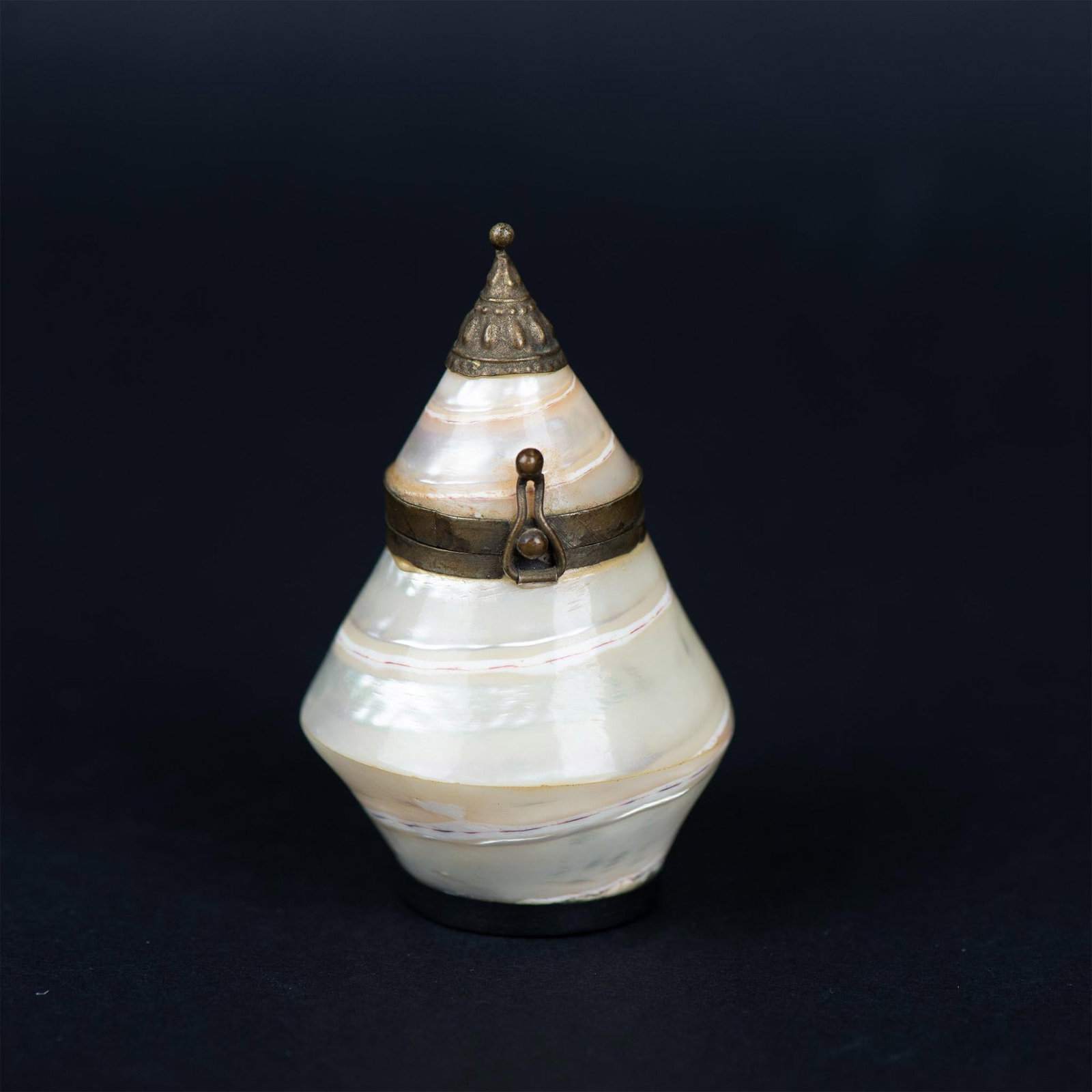 Antique Mother of Pearl Hinged Flip Top Container: This incredible mother of pearl snuff trinket pill box is made from a whole shell. It has a hinged top with a mirror on the bottom so you can see it when the container is opened. Dimensions: 1.75"dia.