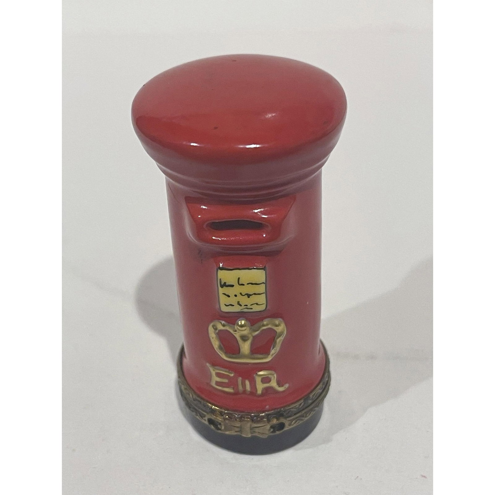 Limoges France Keepsake Box, Red English Mailbox: English Post Mailbox Keepsake Box is a vibrant red hand-painted design with black and 24k gold accents. Gilded double loop closure at hinge opens to reveal two posted letters already inside. There is 