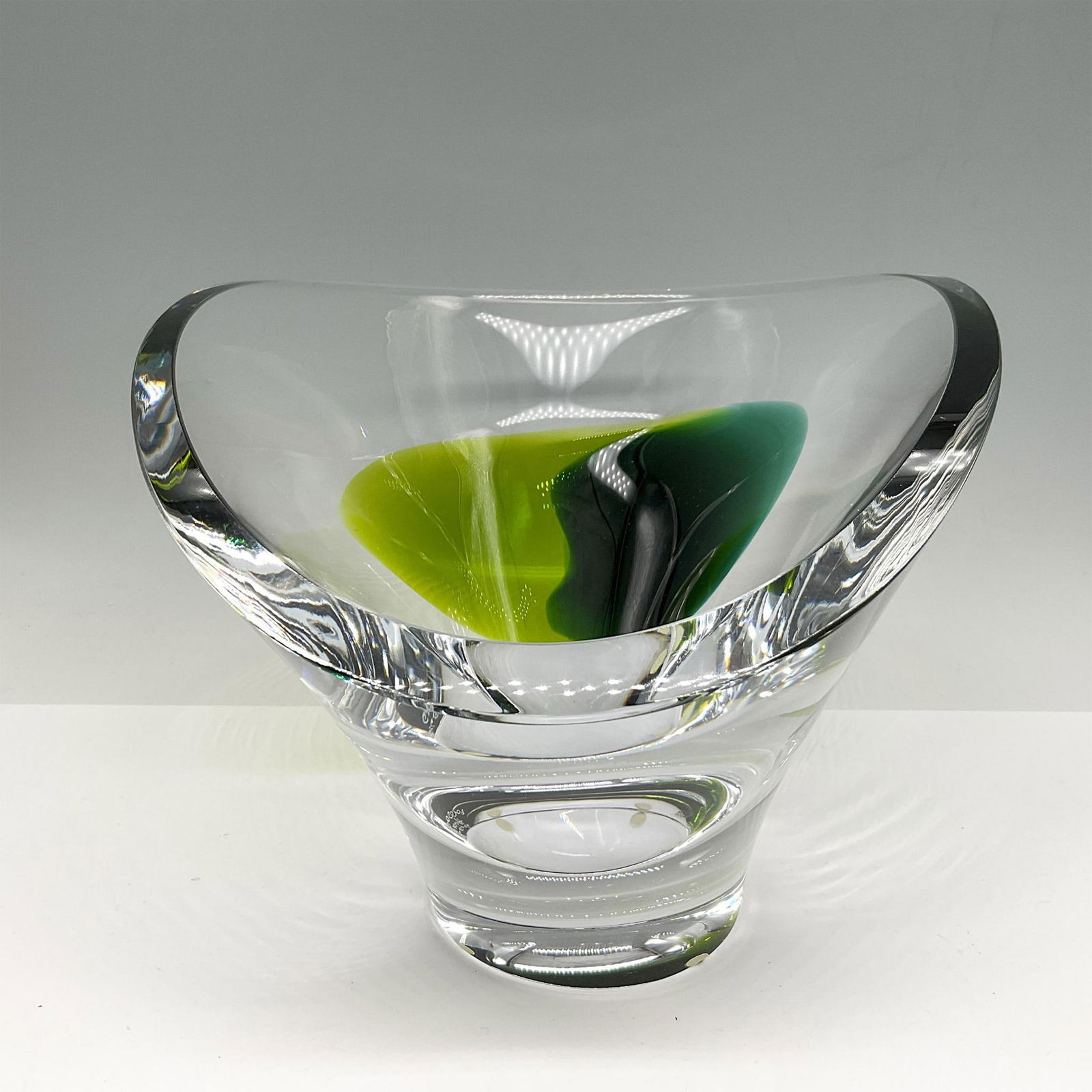 Goran Warff for Kosta Boda Crystal Bowl, Aria: Beautiful angled contemporary bowl with blue, green and lime green accent design. Signed by Artist. Kosta Boda etched mark. 7050208. Artist: Goran Warff Issued: 21st century Dimensions: 8.25"L x 10.25
