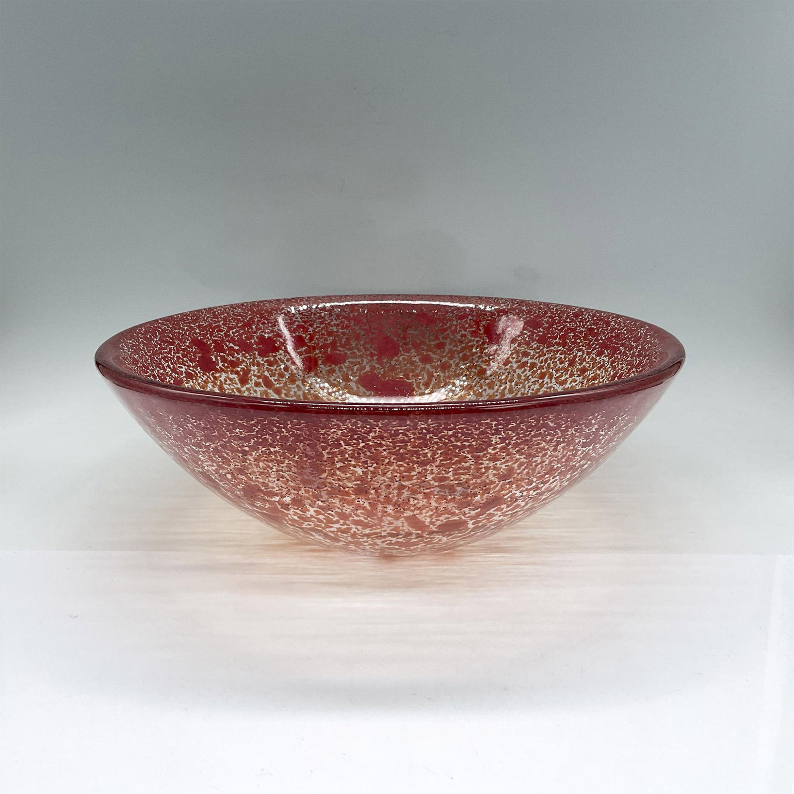 Kosta Boda Glass Bowl, Tellus by Anna Ehrner: Unusual glass bowl in a mottled burnt orange pattern. Kosta Boda etched mark. Includes original box 14"L x 13.25"W x 5.25"H. Artist: Anna Ehrner Dimensions: 4.25"H x 12" dia Manufacturer: Kosta Boda C