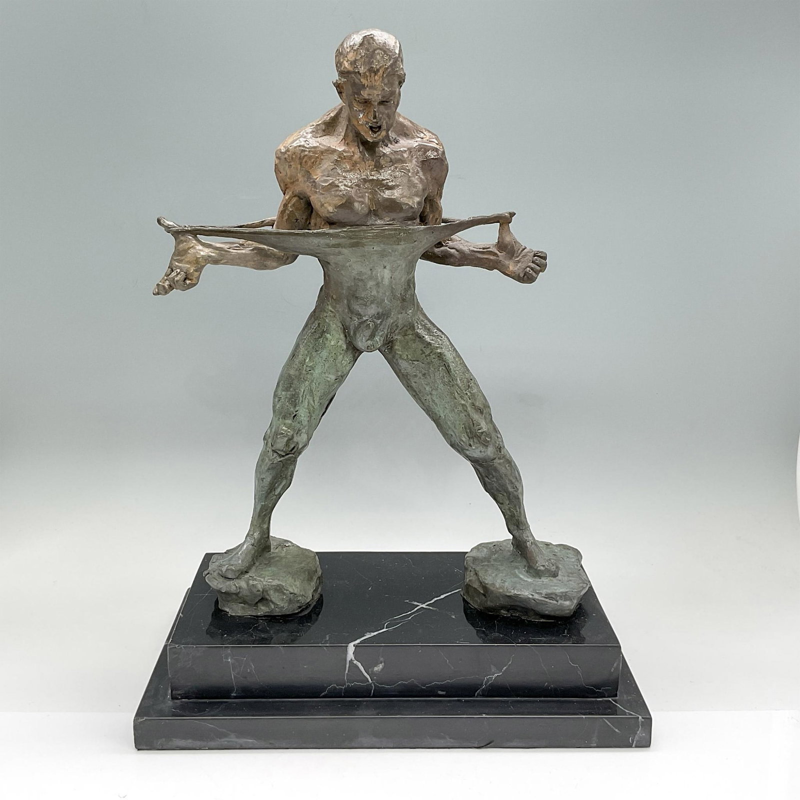 Bronze Sculpture of Ballet Dancer Rudolph Nureyev: Patinated bronze sculpture depicting the male ballet dancer Rudolf Nureyev pulling his shirt while looking down with open-mouthed expression. After Richard MacDonald. Signed Fisher. Dimensions: 10.5"L