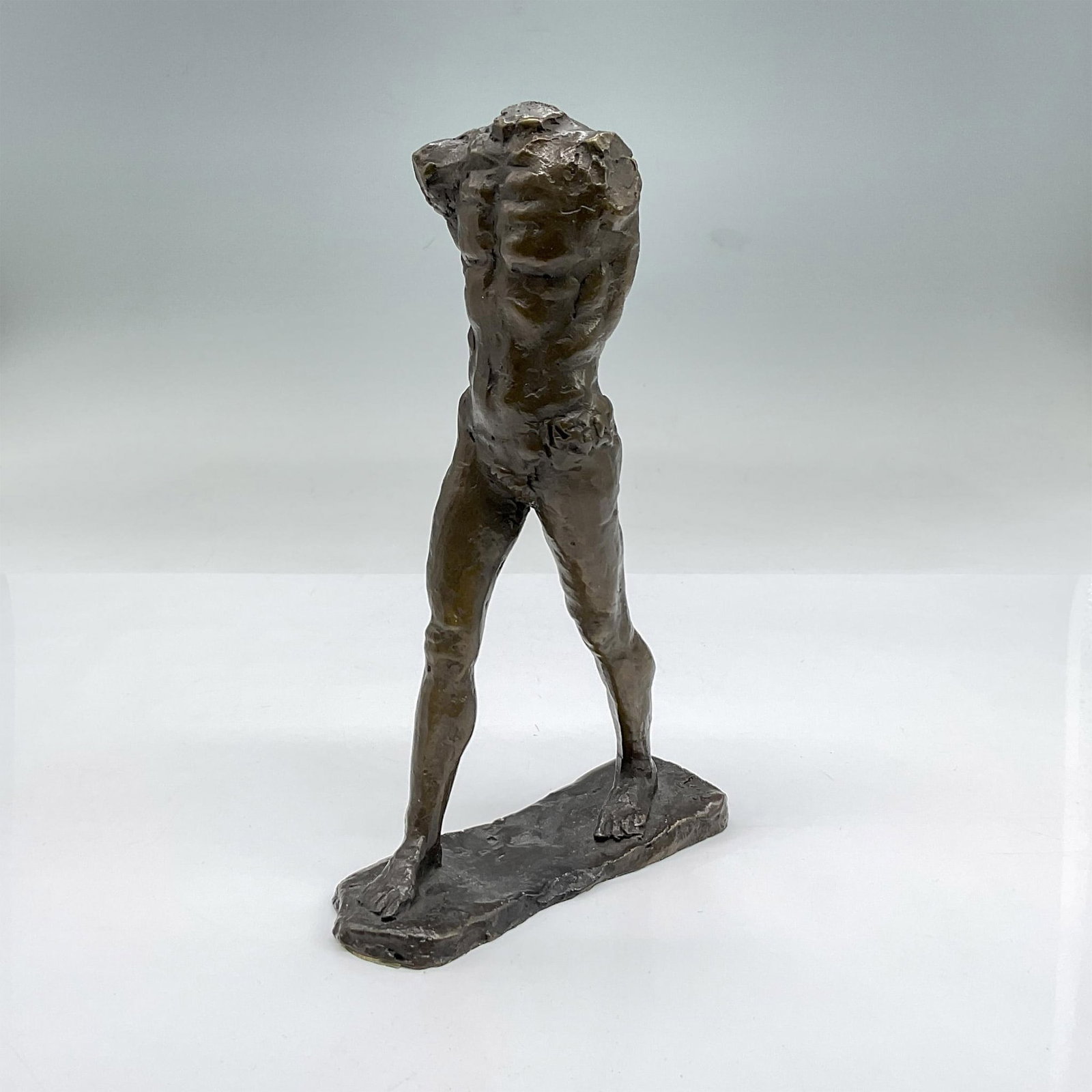 After Rodin Bronze Statuette, Headless and Armless Man: Rodin inspired small bronze statue of a nude man without arms or a head. Dimensions: 4.5"L x 1.5"W x 7"H
