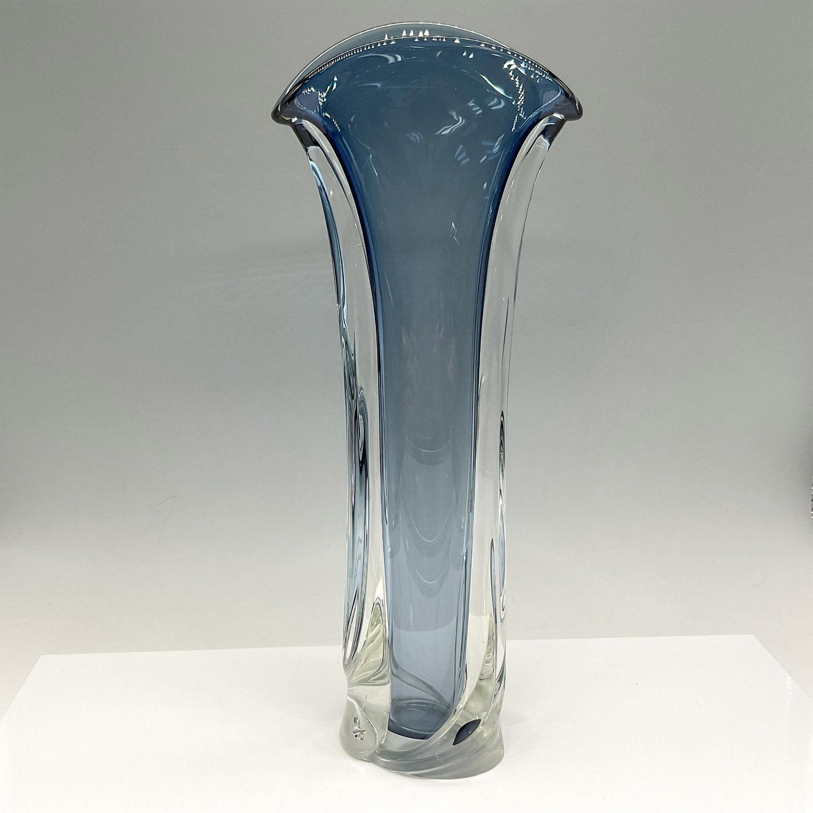 Matthew Buechner Art Glass Vase, Signed: This stunning hand-blown tall tulip formed vase of cased steel blue with clear glass makes a dramatic but elegant statement. Signed by artist. Matthew Buechner etched and dated. Artist: Matthew Buechn