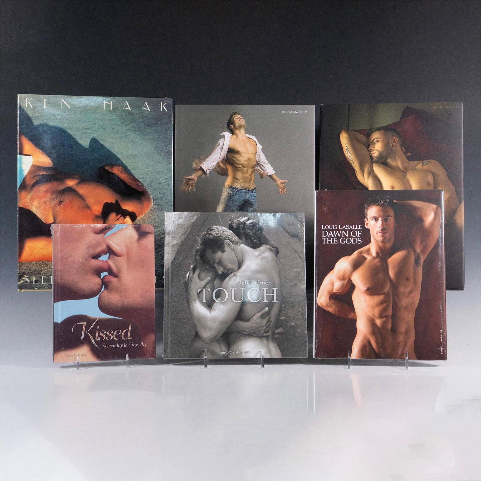 6 Books of Male Erotic Art Photography: An array of colored, and black and white hardcover photography books featuring nude male models in artistic, picturesque settings. Titles includes Men and Gods (2013), and Erotic Dreams (2010) by Davi