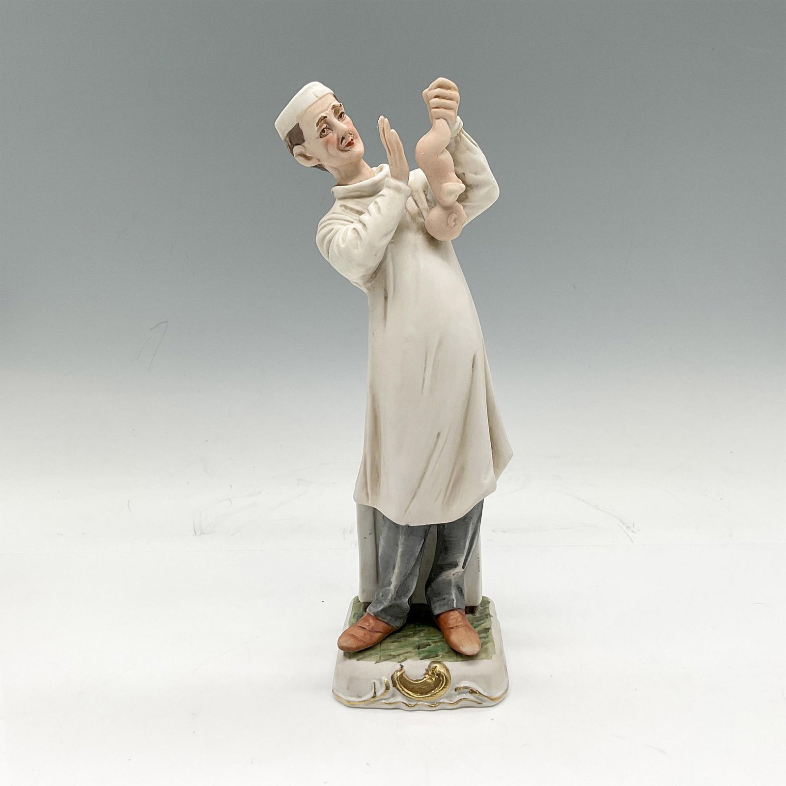 Vintage Arnart Porcelain Figurine, Doctor with Baby: Figural in white hospital gown holding baby. Made in Japan sticker. 11/426. Issued: 20th century Dimensions: 2.5"L x 2.5"W x 8.5"H Manufacturer: Arnart