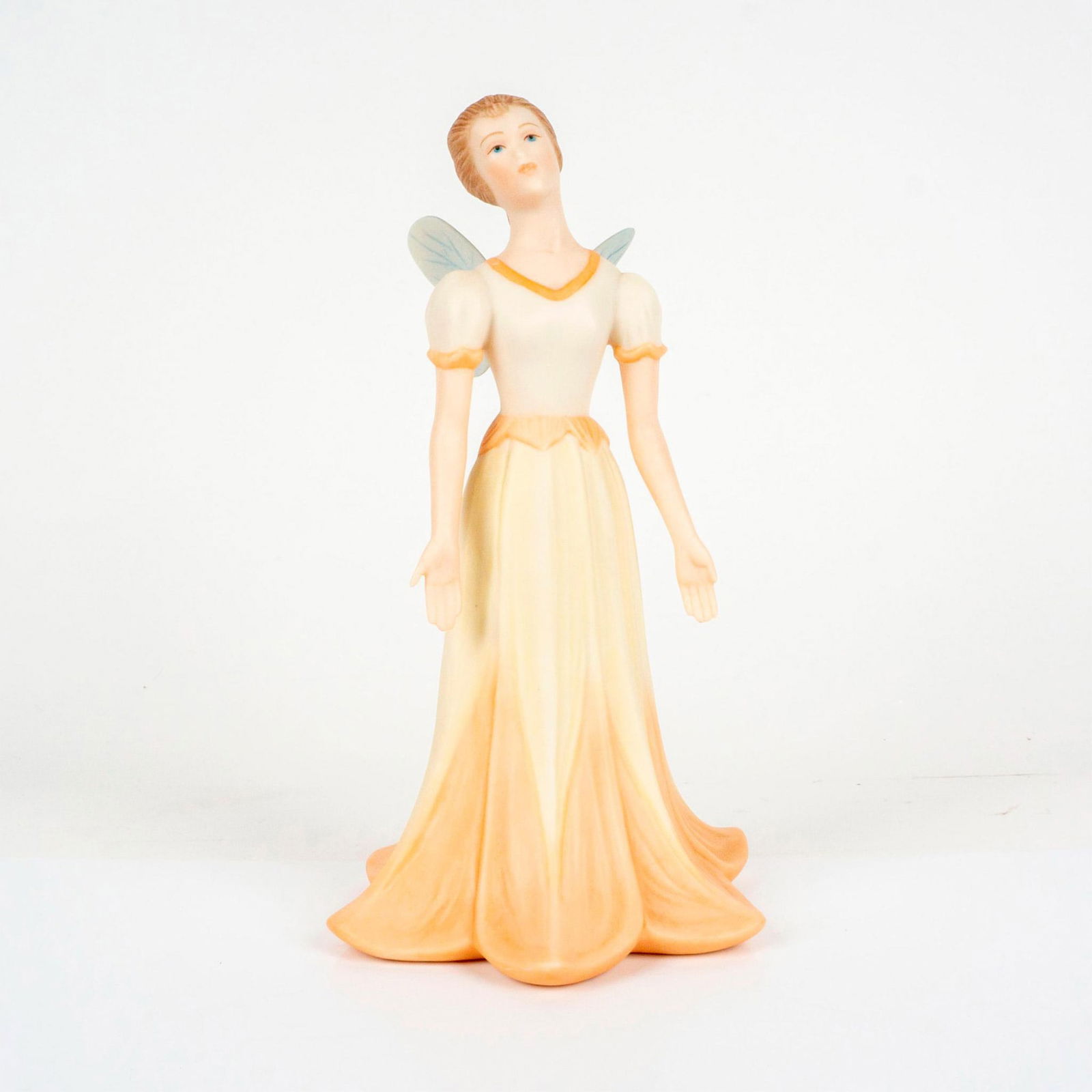 Sugar Plum Fairy - Goebel Porcelain Figurine: Featuring pretty girl with wings. Consists of lovely peach cream and pastel yellow toned coloration. Artist signature printed on bottom of piece. Goebel Crafts of North America and Goebel Made In U.S.