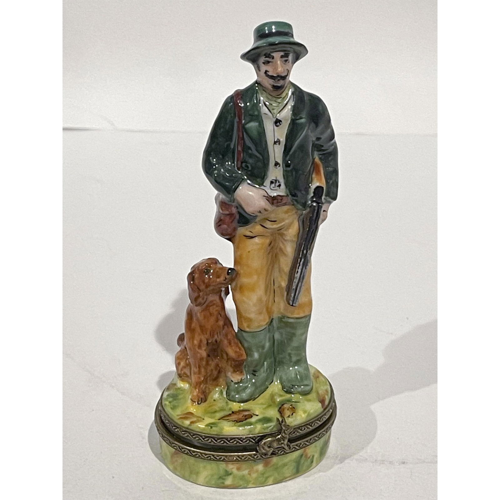 Limoges France Keepsake Box, Hunter with Gun and Dog: Limited Edition hand painted and very detailed mustached hunter carrying a gun and with faithful dog at his feet porcelain hinged mini box. Gilded rabbit at hinge that when opened reveals a running aw