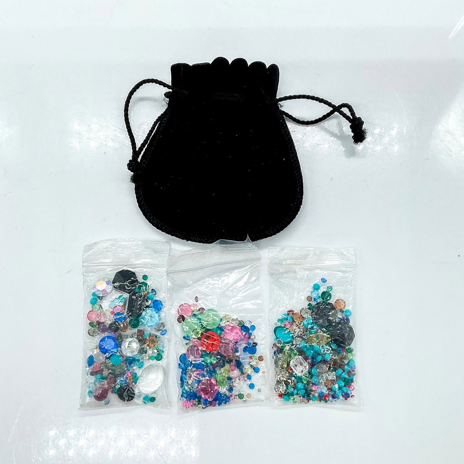 Swarovski Crystal Loose Crystals in Various Colors: Lot of small and tiny crystals of various sizes and colors to use for art or jewelry projects. Dimensions: 4"H pouch Manufacturer: Swarovski