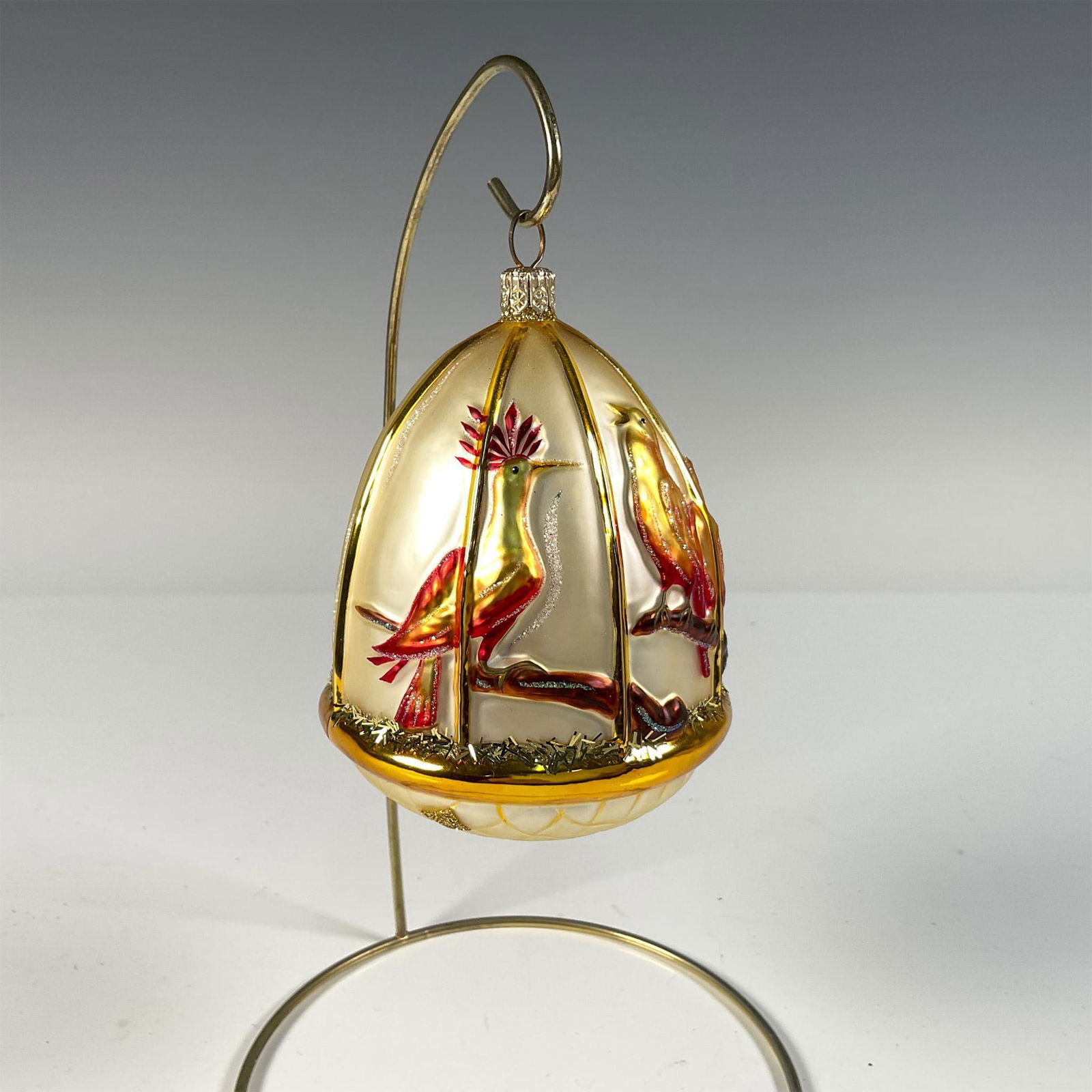 Patricia Breen Christmas Ornament, Four Calling Birds: Hand-crafted, this glass ornament takes the shape of a birdcage adorned with gorgeous red, orange, and yellow birds. Lightly embellished with straw-like glitter, this piece is part of the 12 Days of C