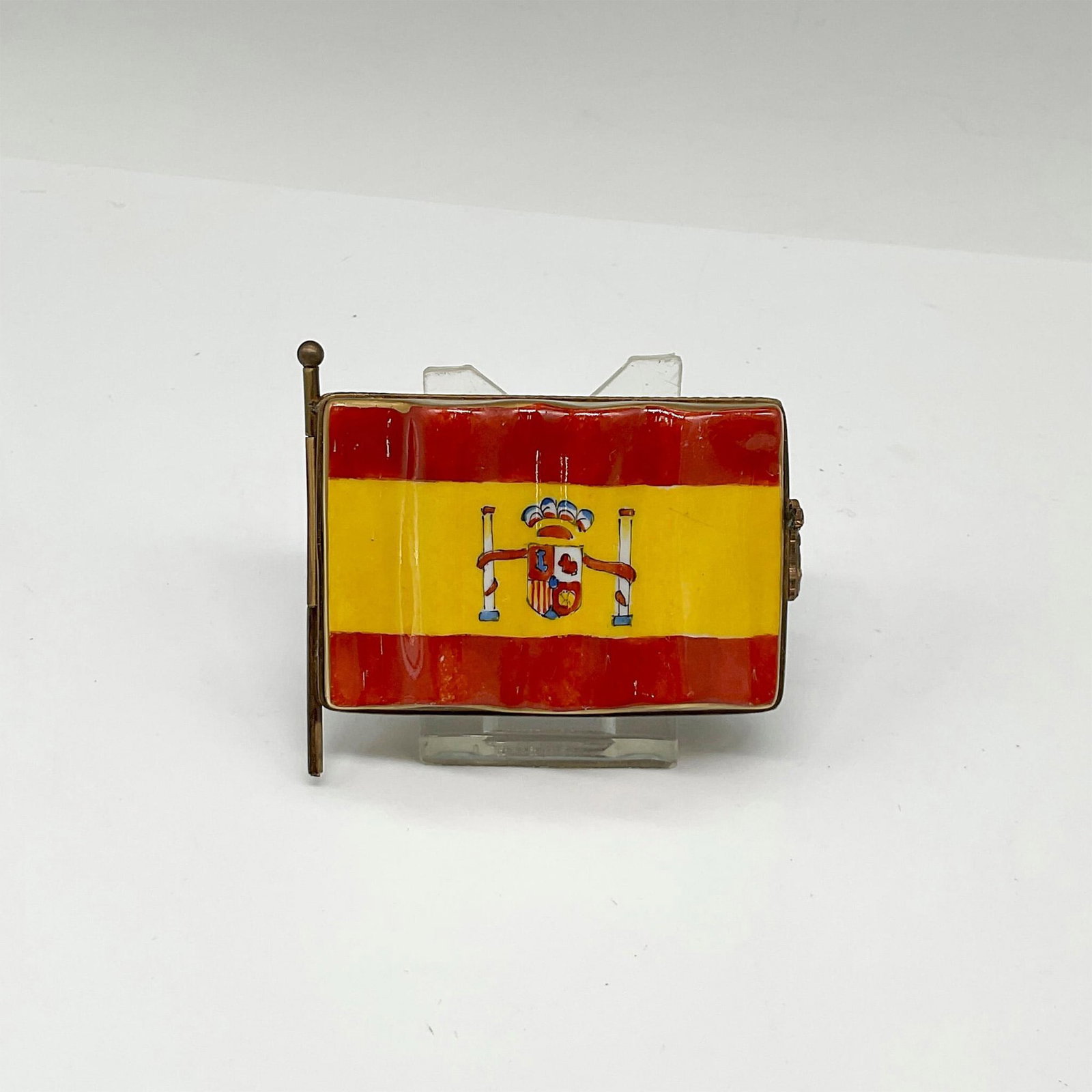 Limoges France Keepsake Box, Spain Flag: Limited Edition hand painted porcelain box shaped as the Flag of Spain with a Cow hinge. Inside the box is a painted outlined map of Spain and the surrounding Countries Portugal and France. Marked by 