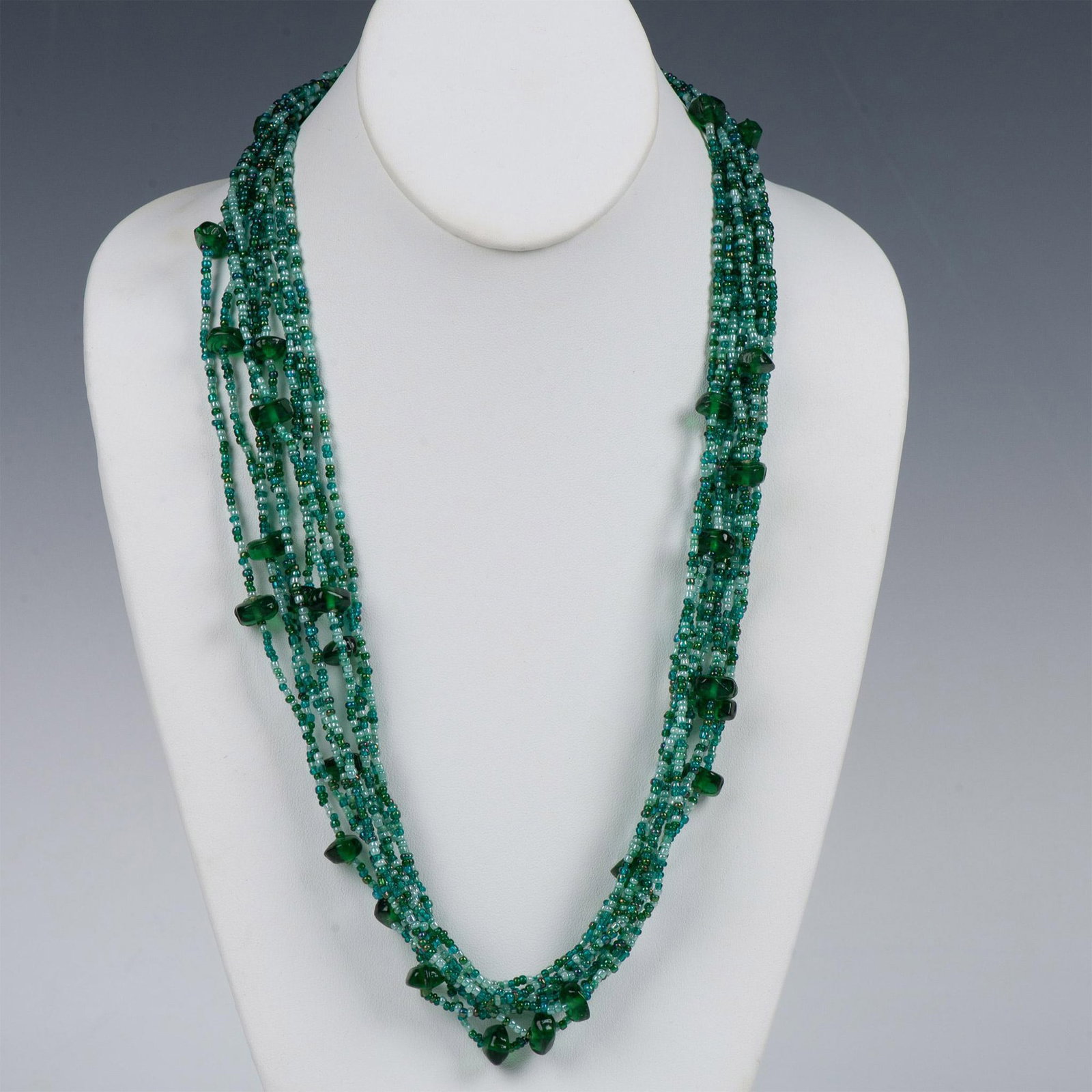 Gorgeous Ten Strand Green and Blue Beaded Necklace: Ten strands of small round beads in different blue and green shades with larger chips of green glass. It measures approximately 27.25"L but can be adjusted shorter.