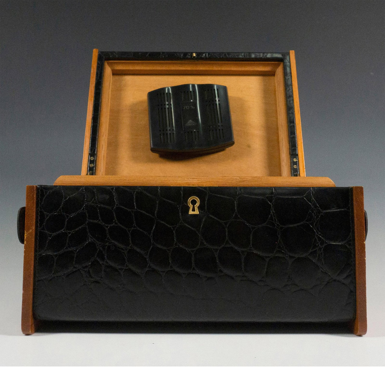 Spanish Black Leather and Wood Cigar Humidor Box: Elegant cigar humidor made of wood, exterior is lined with stunning textured black leather and matching handles. Gold-tone hardware, this cigar box locks and includes a key. Dimensions: 11.25"L x 8"W 