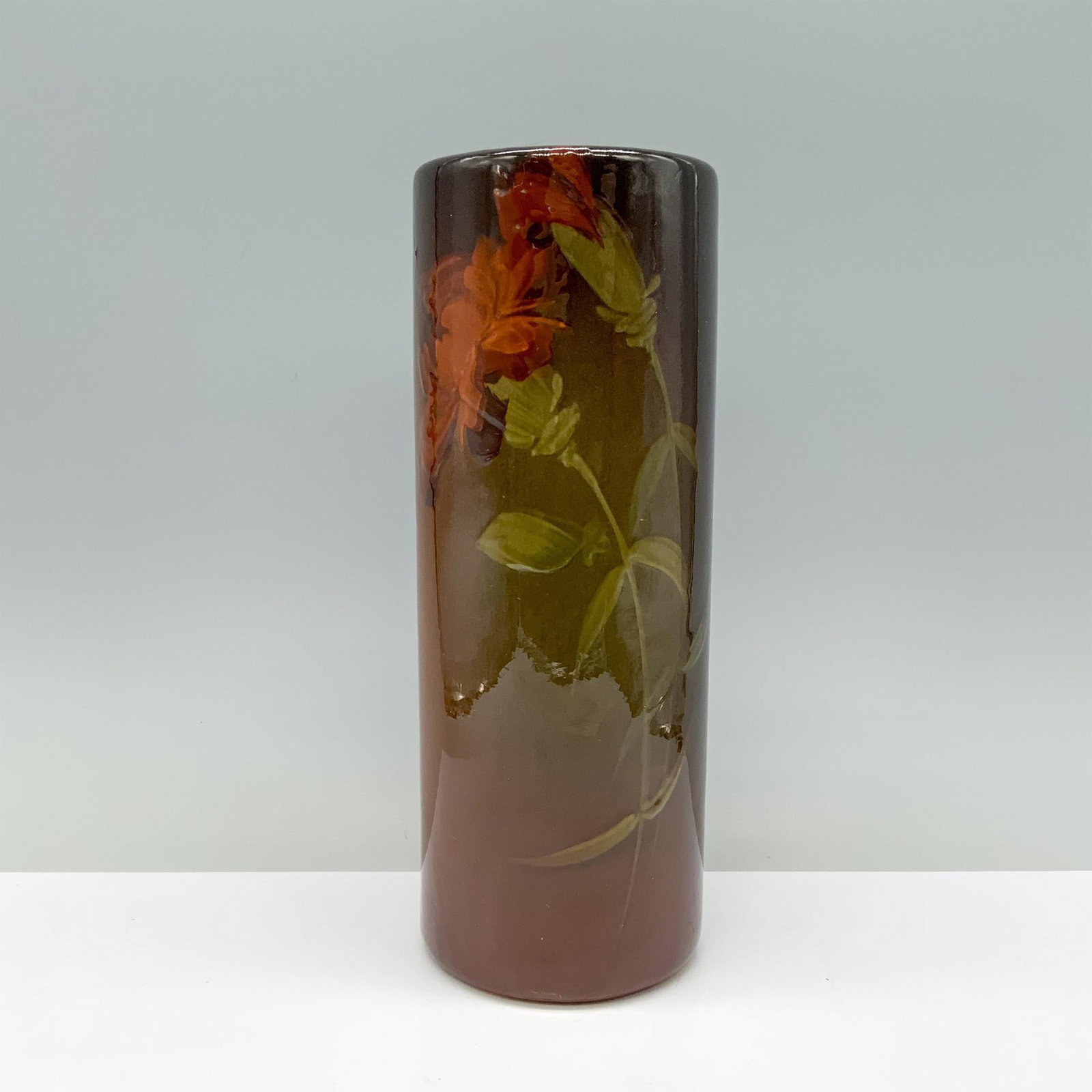 American Art Pottery Vase, Red Peony: A stunning brown and auburn glazed round vase featuring vibrant red peonies painted on its surface. Dimensions: 8.5"H x 3.25" dia. Country of Origin: United States