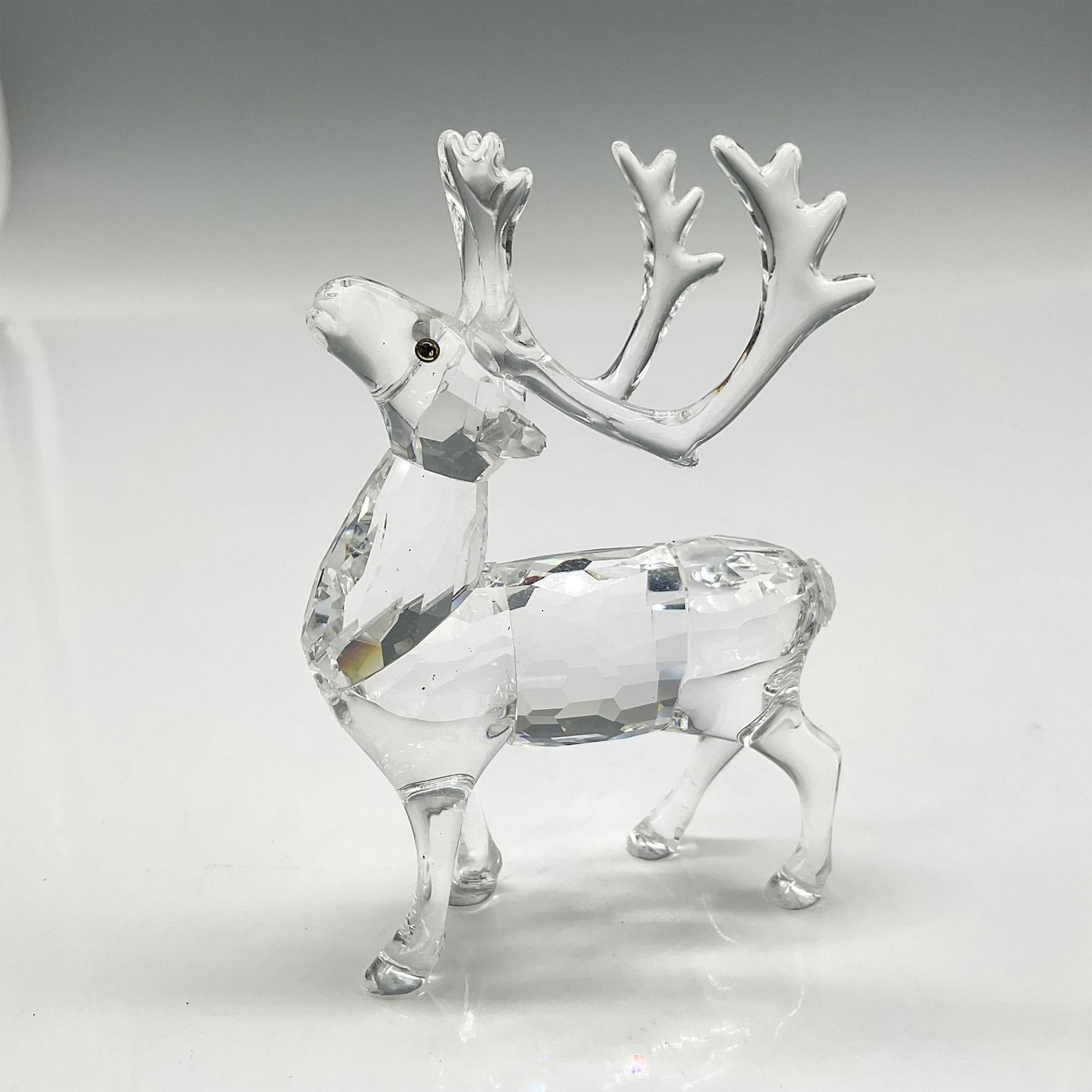 Swarovski Silver Crystal Figurine, Reindeer: Part of the Exquisite Accents group this crystal figurine has a faceted body, clear smooth haunches and antlers with amber colored crystal eyes. Swarovski backstamp. 7475 000 602. This item has its or