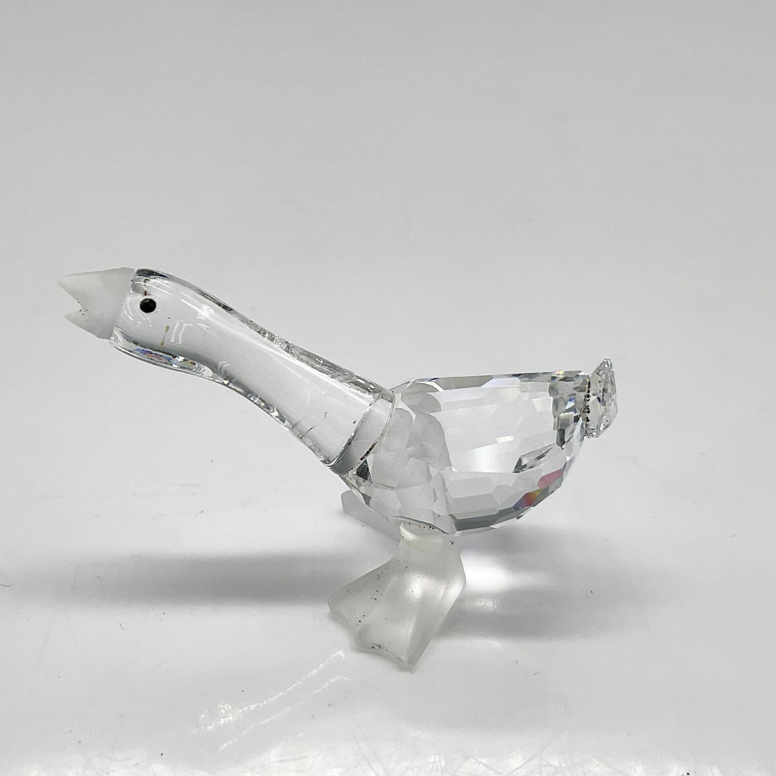 Swarovski Silver Crystal Figurine, Harry Gosling: Part of the Barnyard Friends collection. Clear crystal smooth neck with frosted beak and legs and black crystal inset eyes. Swarovski backstamp. 7613 000 003. This item has its original box: 2.5"H x 3