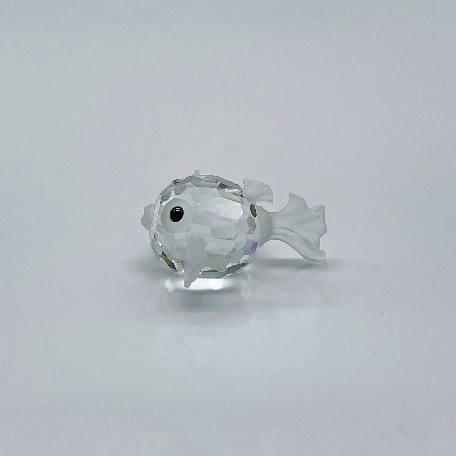 Swarovski Silver Crystal Figurine, Mini Blowfish: Clear faceted crystal puffer fish with frosted tail, fins and mouth. Swarovski mark. Includes original box: 2.5"H x 3.25"dia. Issued: 1987-2005 Dimensions: 1.25"L x 1.25"W x 0.75"H Manufacturer: Swaro