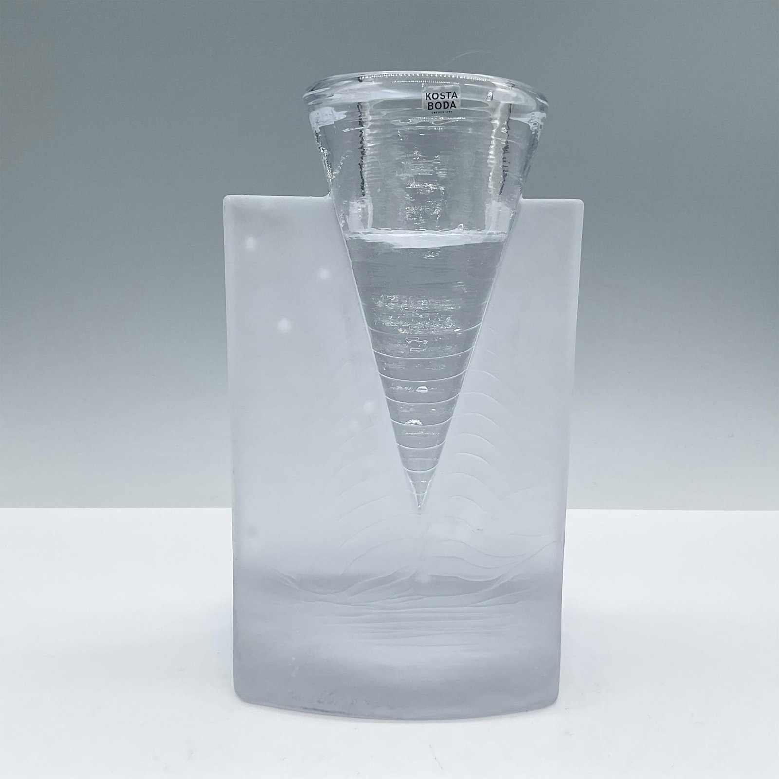 Kosta Boda Crystal Candle Holder, Ice Age: Clear crystal cone holder inserted in a frosted crystal base with fluid designs. Kosta Boda original tag and etched backstamp. Artist: Kjell Engman Issued: 2004 - 2009 Dimensions: 4.75''L x 4''W x 7.7