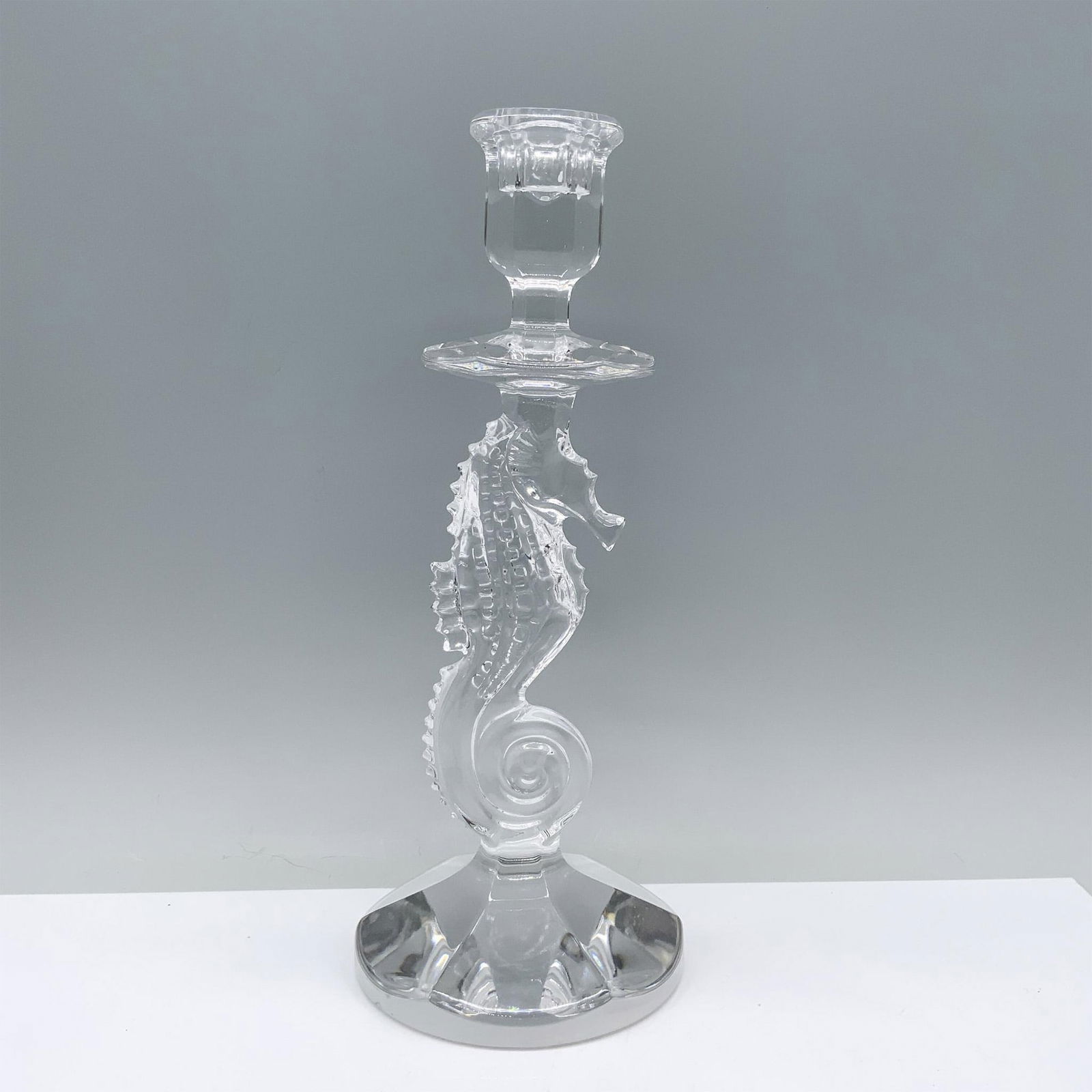 Waterford Crystal Candlestick, Seahorse: A captivating clear candlestick featuring a sturdy round base, adorned with a finely detailed seahorse centerpiece, culminating in a bell-shaped candle holder. Marked Waterford. Issued: 2003 Dimension