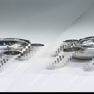5pc Swid Powell Silver Plated Bowl and Napkin Holders: Deigned by Richard Meier; a small round bowl in the Skyscraper design, and 4 napkin ring holders. Silver plated with rectangular and square cuts. Marked Swid Powell RM. Bowl: 2"H x 6" dia. Napkin hold
