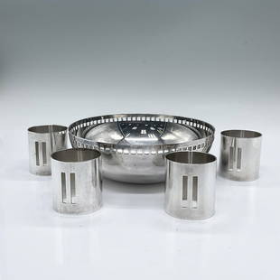 5pc Swid Powell Silver Plated Bowl and Napkin Holders: Deigned by Richard Meier; a small round bowl in the Skyscraper design, and 4 napkin ring holders. Silver plated with rectangular and square cuts. Marked Swid Powell RM. Bowl: 2"H x 6" dia. Napkin hold