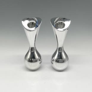 Pair of Nambe Metal Tulip Candlestick-Bud Vases: Silver toned metal holder in hourglass shape can play a dual role and is a nice touch for any occasion. Nambe mark. This item has its original box: 7"L x 7"W x 3"H. Artist: Karim Rashid Issued: 2005 D