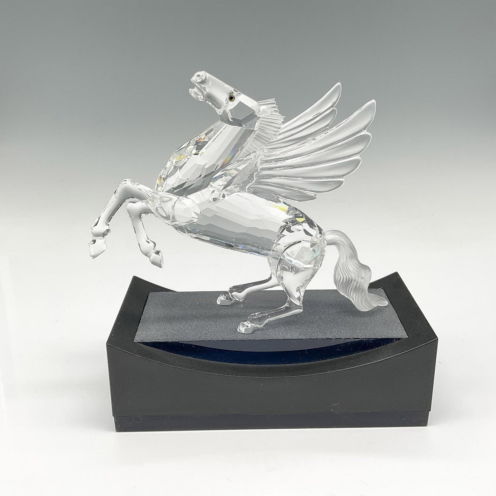 Swarovski SCS Figurine, 1998 The Pegasus + Base: Gorgeous mythical creature with his wings spread wide, rearing back, he looks majestic. Body is clear faceted crystal with his mane and tail in satin crystal. He finalizes the Fabulous Creatures trilo