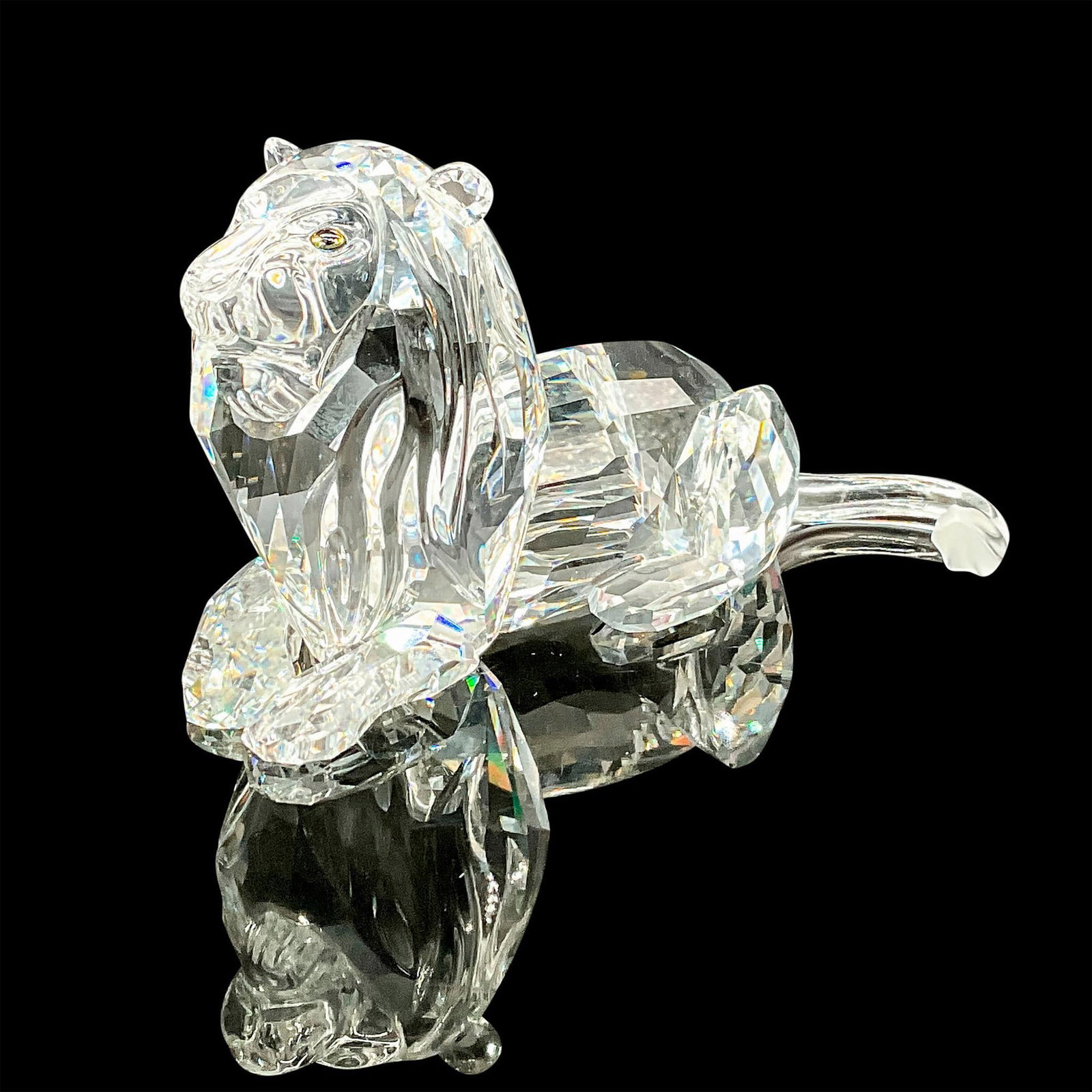 Swarovski Crystal Figurine, Lion: Final piece of the Inspiration Africa trilogy. Annual edition clear crystal lion seated gracefully with frosted crystal. Swarovski etched backstamp. This item has its original box. Box measures: 7.75"