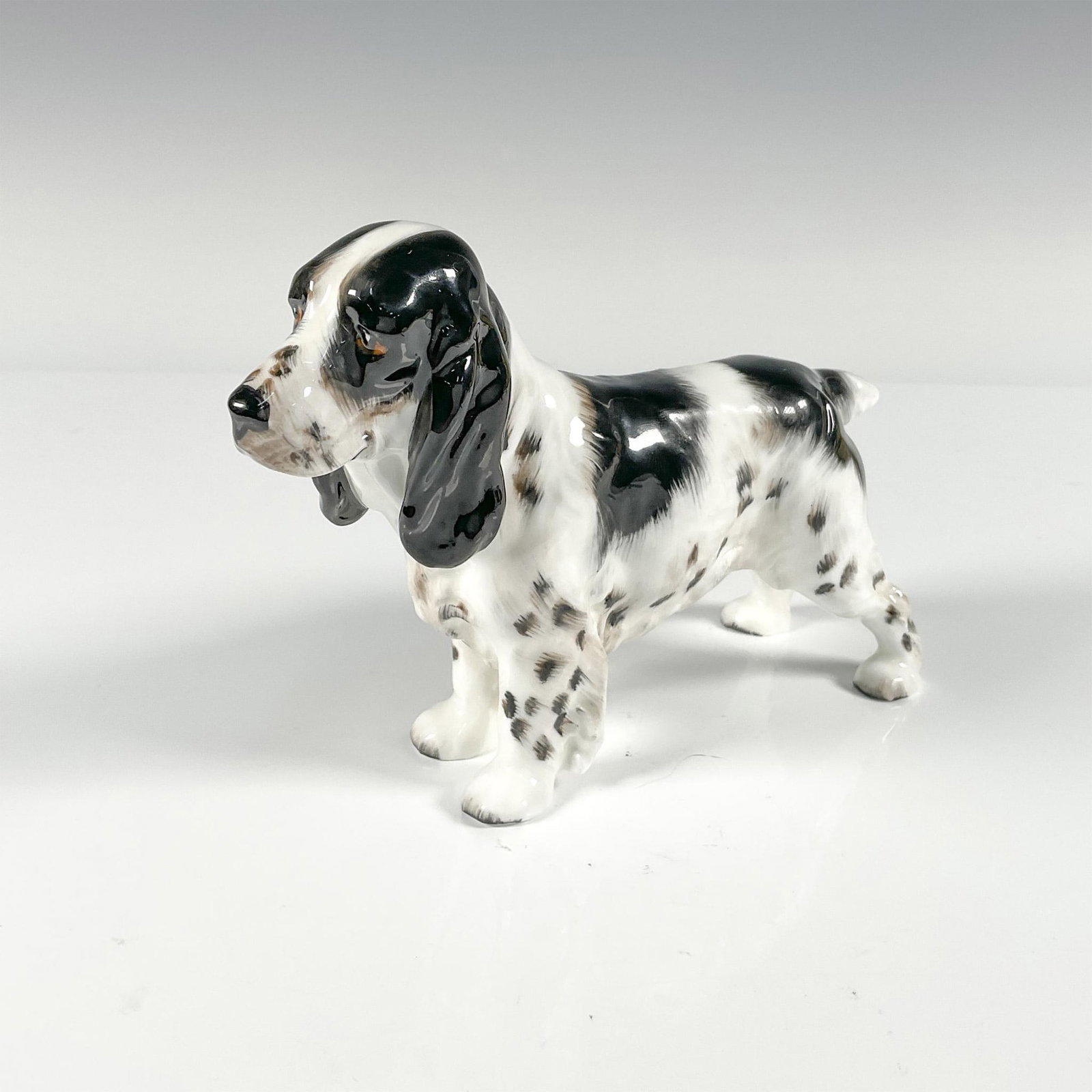 Springer Spaniel - HN1109 - Royal Doulton Dog Figurine: Porcelain dog figurine, Springer Spaniel HN1109. Gloss finish. Royal Doulton backstamp in green. Issued: 20th century Dimensions: 7"L x 2"W x 5"H Manufacturer: Royal Doulton Country of Origin: England
