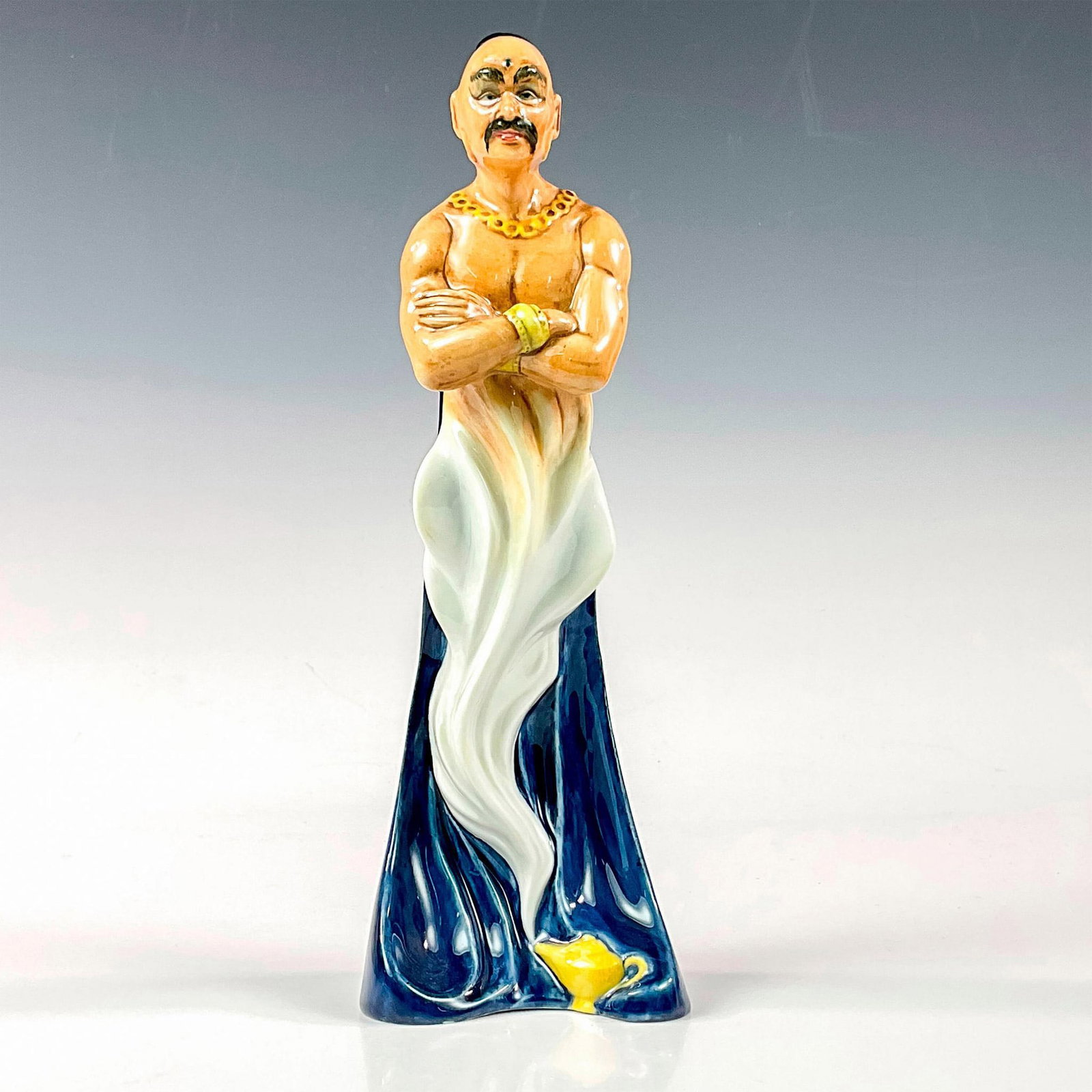 Genie HN2989 - Royal Doulton Figurine: Genie with gold chain and bracelets rising from a lamp. Royal Doulton backstamp. Artist: Robert Tabbenor Issued: 1983 - 1990 Dimensions: 9.75"H Manufacturer: Royal Doulton Country of Origin: Engl