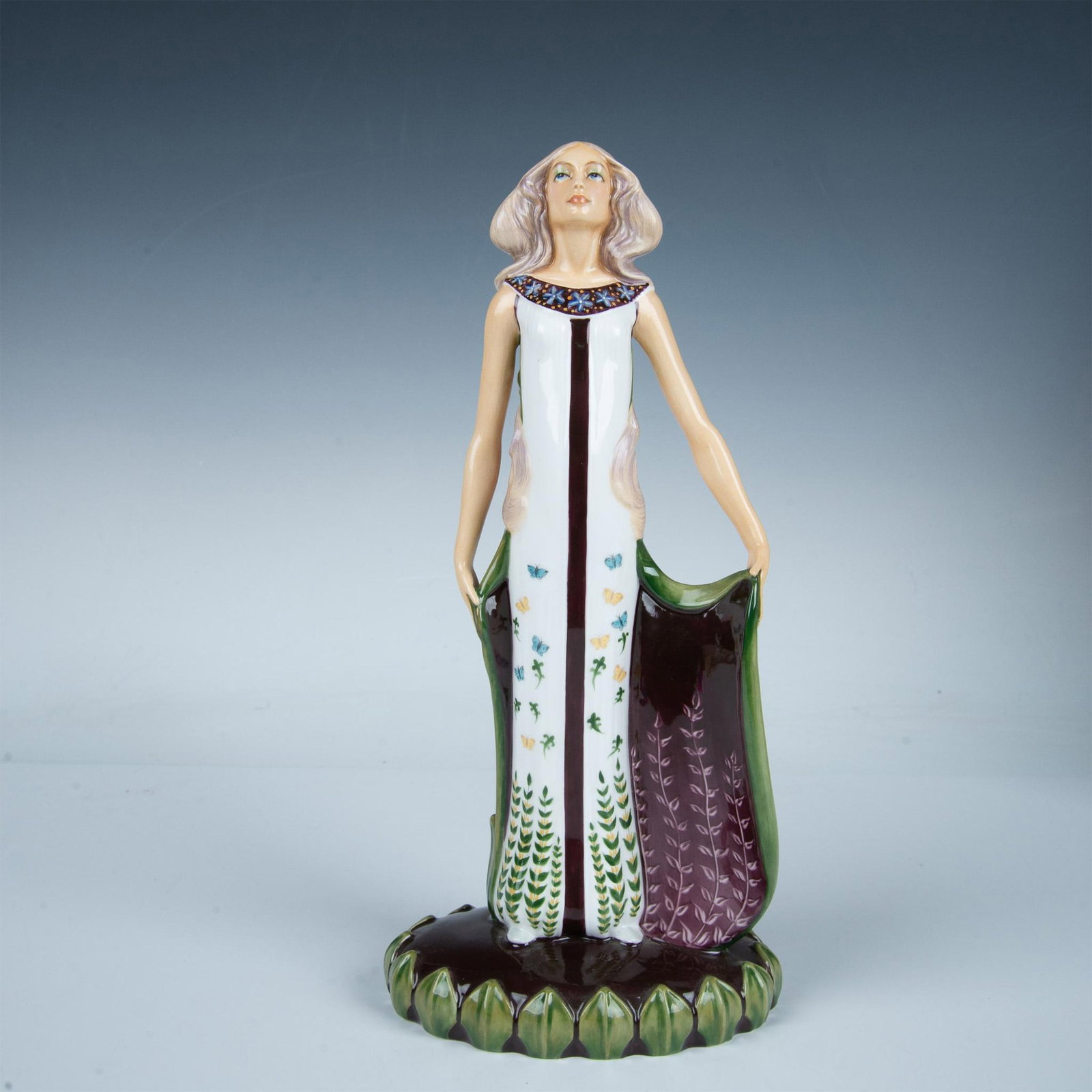 Les Saisons Printemps HN3066 - Royal Doulton Figurine: Bone china figure of a lady representing Spring in a long white dress decorated with blue and yellow butterflies and green leaves. Second in a series of four. Royal Doulton backstamp. Includes origina