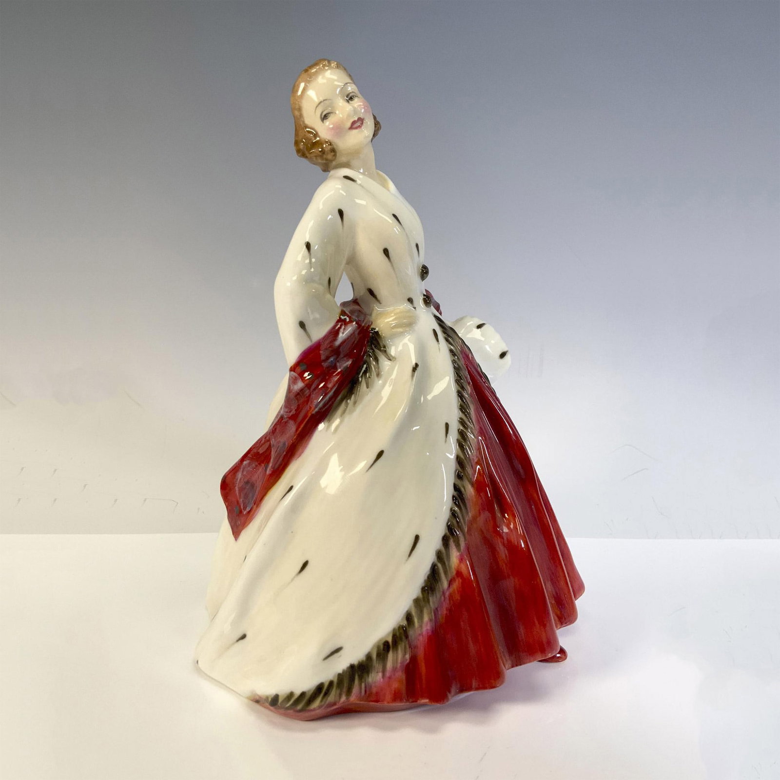 Ermine Coat HN1981 - Royal Doulton Figurine: Showing off her stunning white coat with black spots and matching muff, Figure is a study for the fashion conscious. Royal Doulton backstamp. Artist: Leslie Harradine Issued: 1945 - 1967 Dimensions: 5
