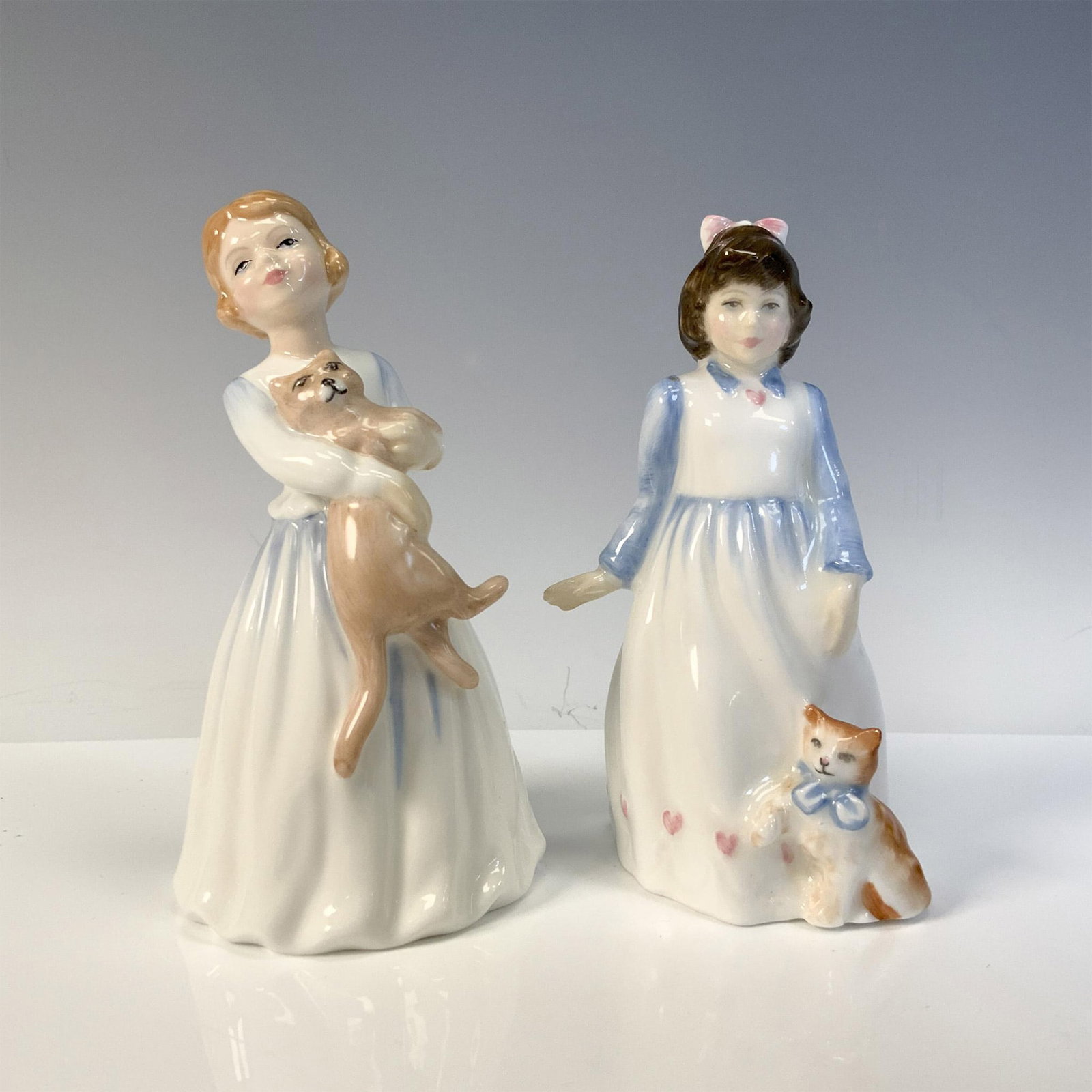 My First Pet HN3122 + Kitty HN3876 - Royal Doulton Figurines: Glossy, hand painted cute figures designed with their cats, My First Cat and Kitty. Royal Doulton backstamp. Artist: Alan Masalankowski Issued: 1991 - 1997 Dimensions: 2.5"L x 2.5"W x 5"H Manufacturer