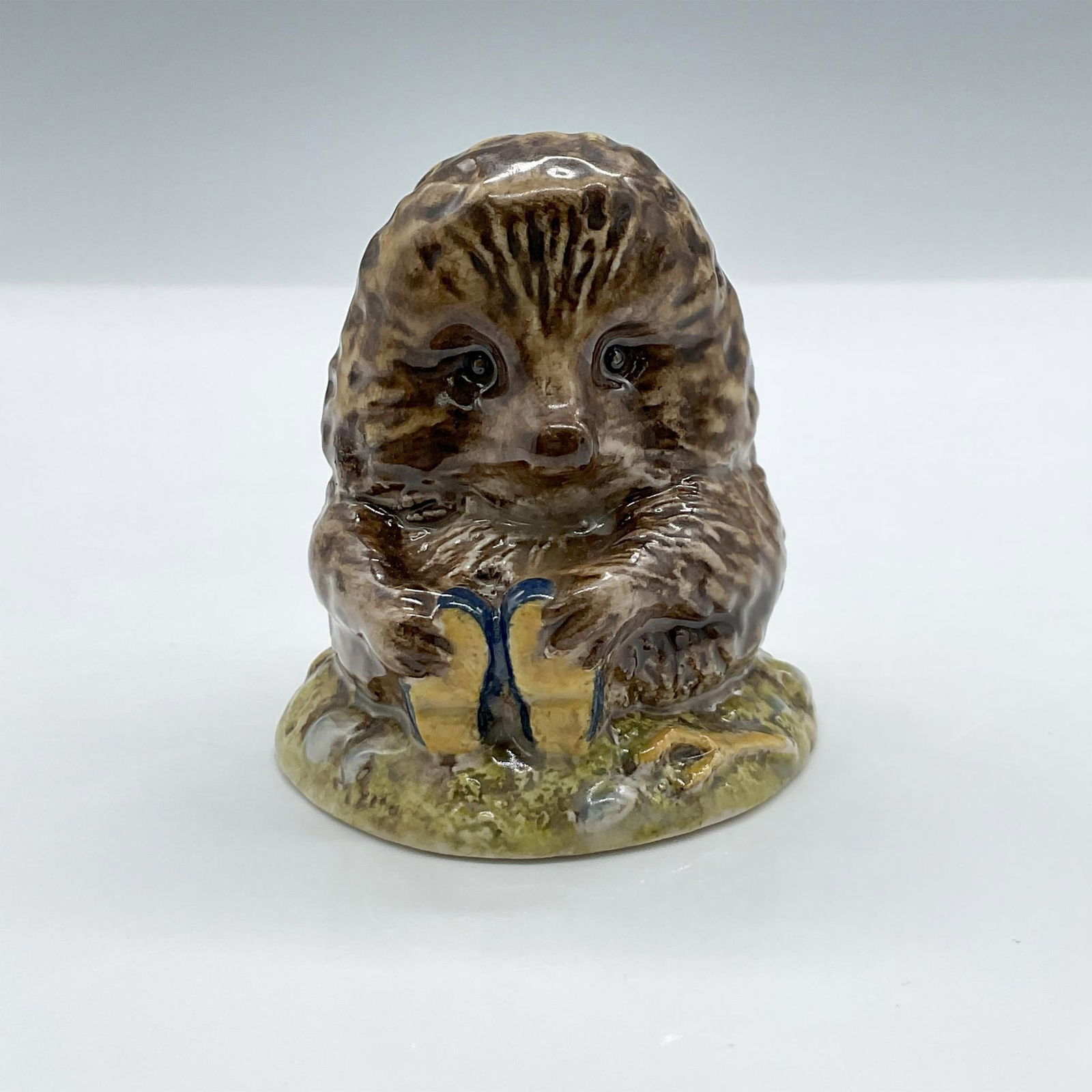 Beswick Beatrix Potter Figurine, Old Mr. Pricklepin: Cute hedgehog wearing blue shoes. The retired piece is made of porcelain with glossy finish. Frederick Warne P.L.C. and Beswick backstamps. Artist: David Lyttleton Issued: 1983-1989 Dimensions: 2.25"L