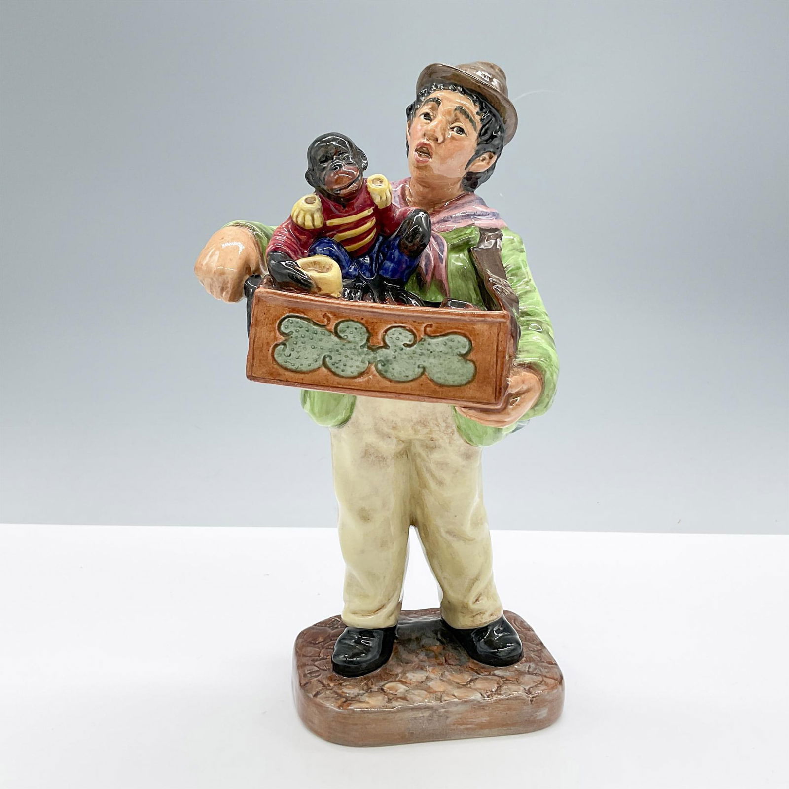 Organ Grinder - HN2173 - Royal Doulton Figurine: Artist: Mary Nicoll Issued: 1956 - 1965 Dimensions: 8.75"H Manufacturer: Royal Doulton Country of Origin: England