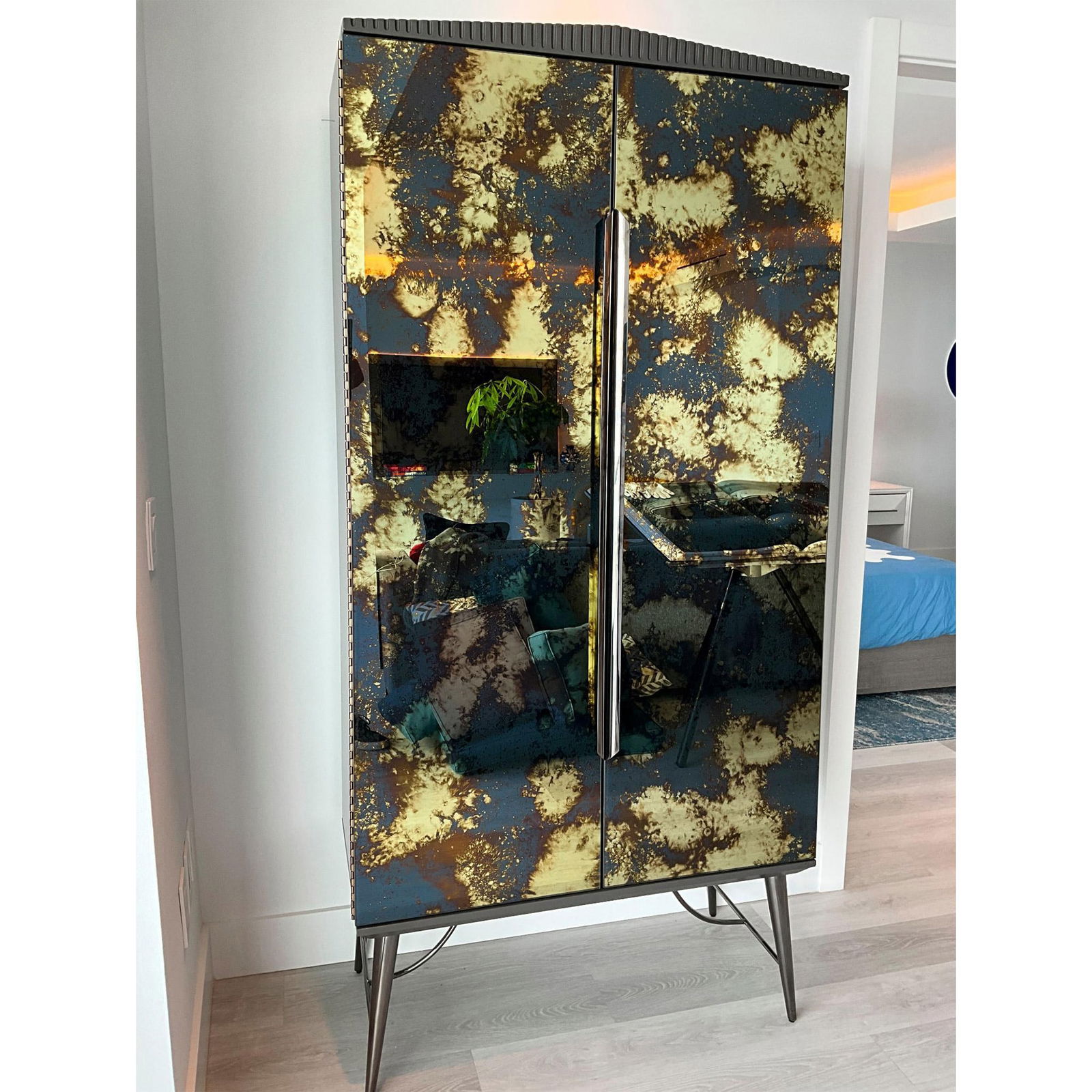 Caracole Designer Cabinet Bar, Mid Century: This bar cabinet mixes neoclassical elements with mid-century modern design for a collected over time aesthetic. Defined by Venetian antique mirrored door fronts and a warm slate finish, its tall tape