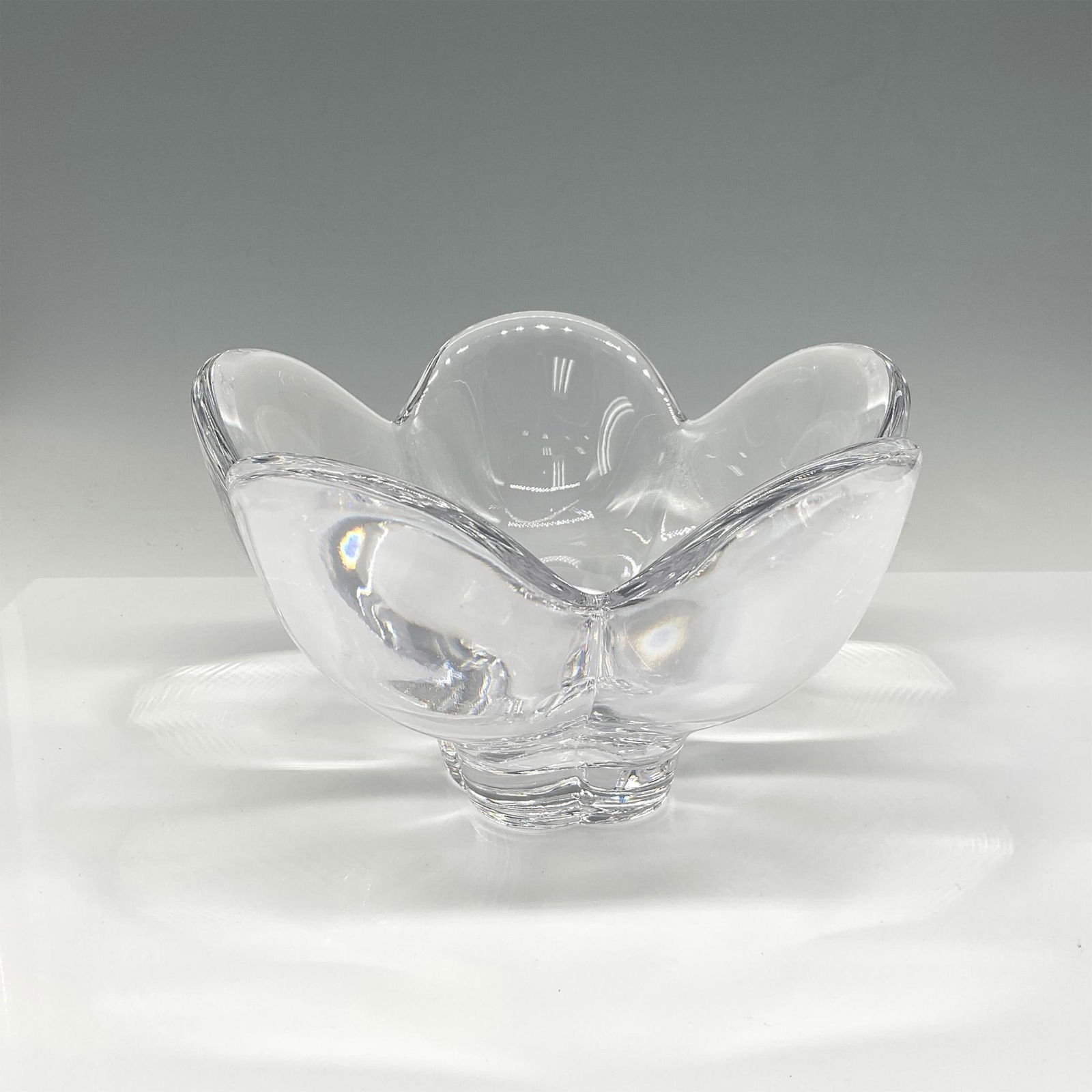 Orrefors Crystal Lotus Bowl: The heart of your table will be this crystal floral expression with its broad leaves and footed base. Orrefors etched mark. Issued: 21st century Dimensions: 5"H x 8" dia. Manufacturer: Orrefors Countr