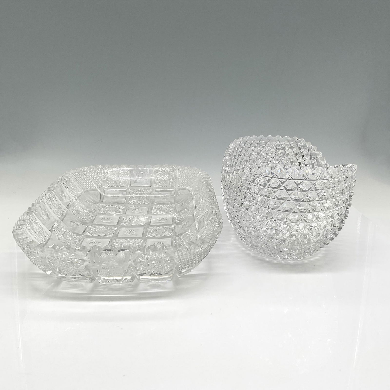 2pc American Brilliant and Cut Crystal Serveware: Rectangular dish with spiral cut and crimped edge design along with half-moon fruit bowl with star and crosshatch design. Issued: 20th century Dimensions: 8"L x 12"W x 2.25"H