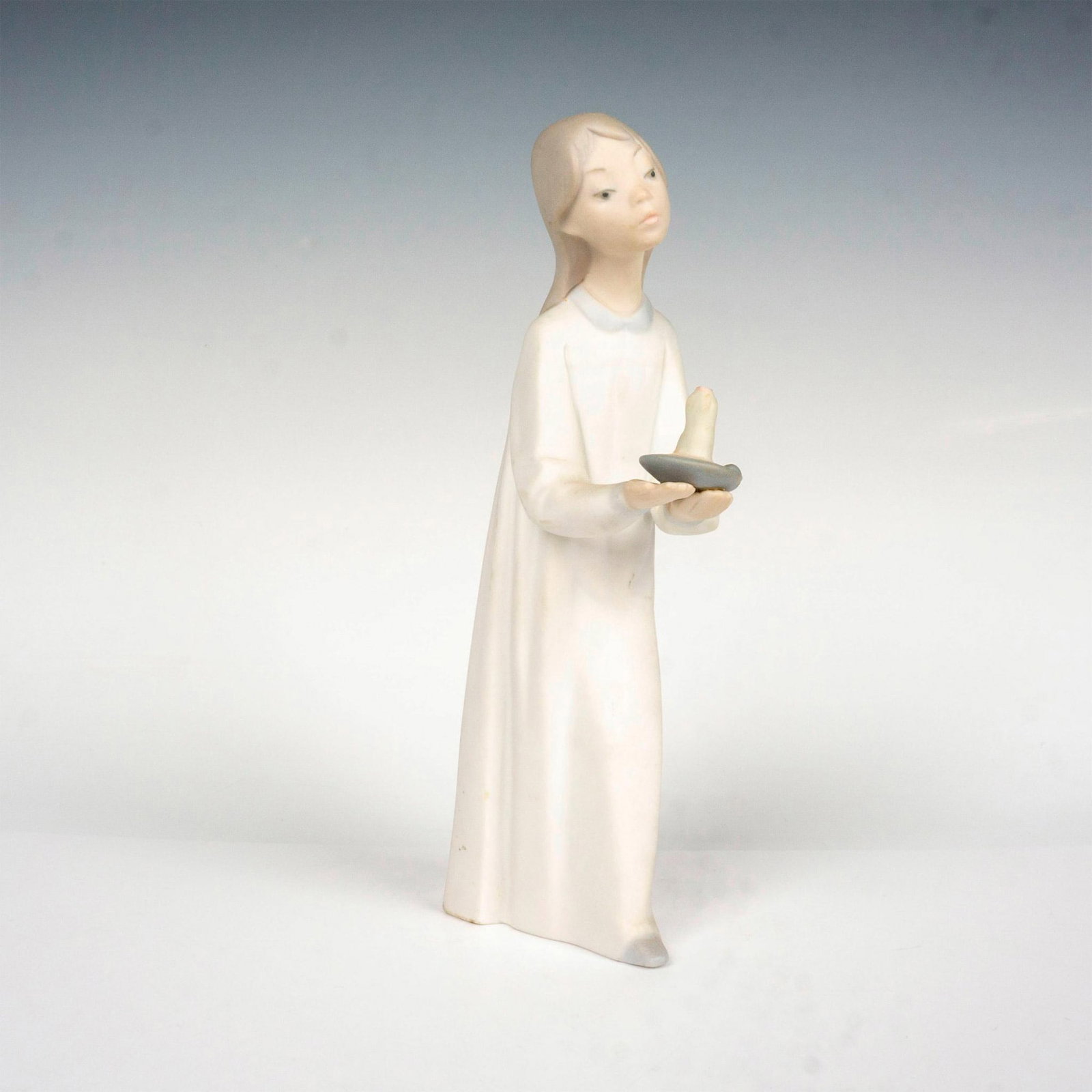 Girl With Candle 1014868 - Lladro Porcelain Figurine: Matte finish; Lladro backstamp. Artist: Fulgencio Garcia Issued: 1974-2000 Dimensions: 8.25"H Manufacturer: Lladro Country of Origin: Spain