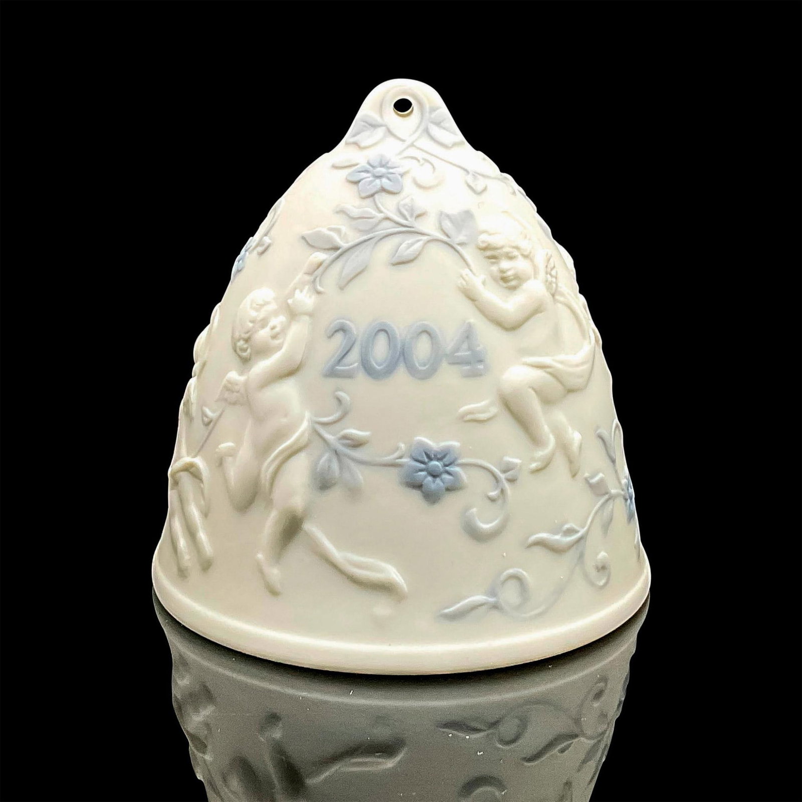 2004 Christmas Bell 1016737 - Lladro Porcelain Ornament: Matte finish; Lladro backstamp. Includes original box measuring 4.75"L x 4.5"W x 4"H. Artist: Miguel Angel Santaeulalia Issued: 2004 - 2004 Dimensions: 3.25"H x 3.25"W Manufacturer: Lladro Country of